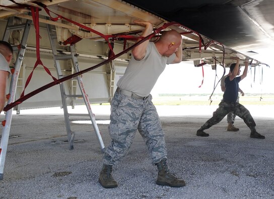 ANDERSEN AIR FORCE BASE, Guam - Senior Airman James Lowery, and Senior Airman Louie E. Gaitan, 36th Expeditionary Aircraft Maintenance Squadron weapons load crew members, open a B-2 Spirit weapons bay door before loading the aircraft with munitions. The Airmen are deployed to Andersen Air Force Base, Guam, from Whiteman AFB, Mo. The B-2 flew in Polar Lightning, a long distance training mission, from Andersen AFB to Elmendorf AFB, Alaska, and back. (U.S. Air Force photo by SrA Christopher Bush) 