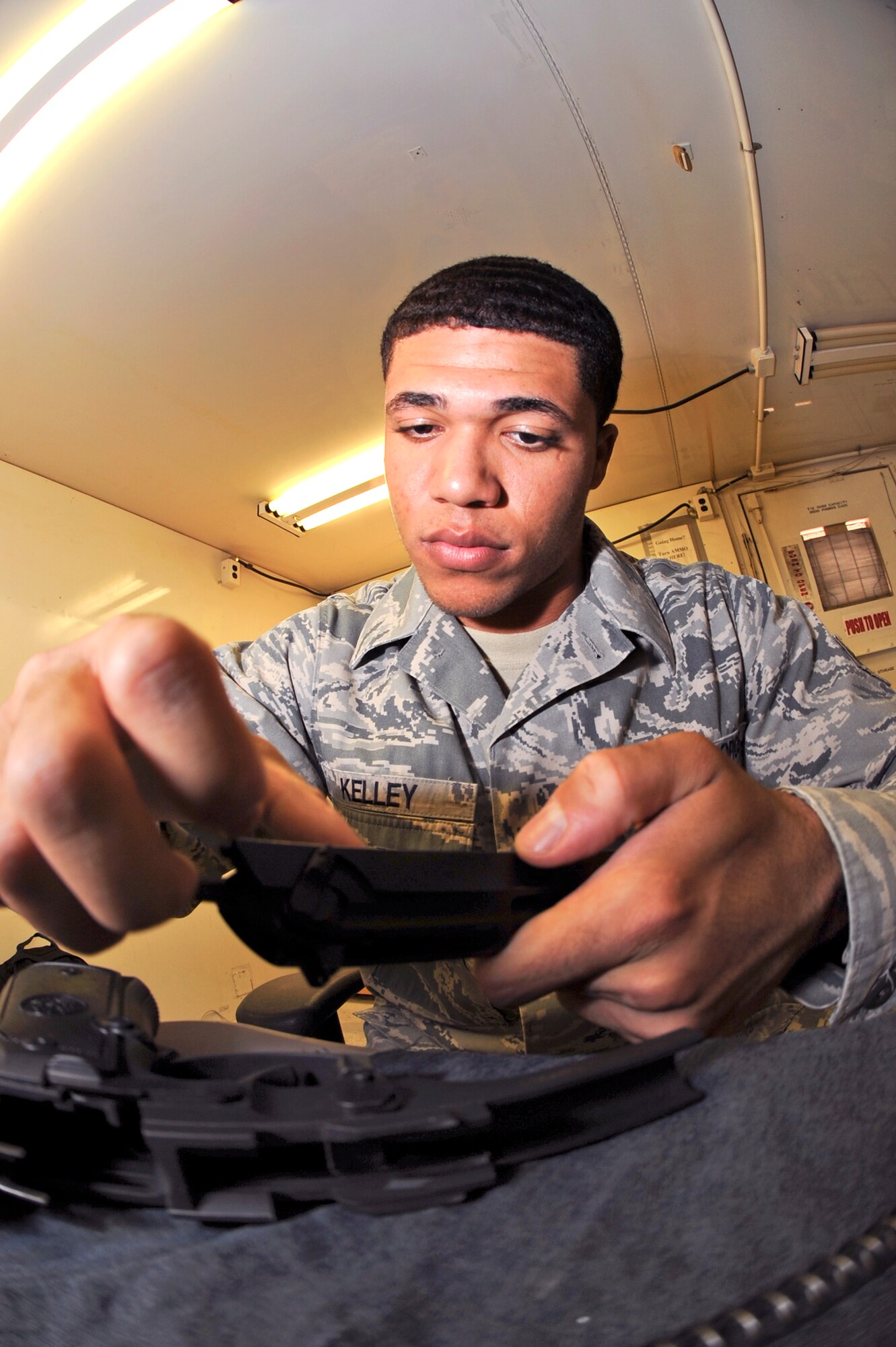 Airman 1st Class Jonathan Kelley, a supply journeyman for the 379th Logistic Readiness Squadron, re-assembles a 9mm pistol at the armory after cleaning the weapon, May 14, 2009, in an undisclosed location in Southwest Asia.  Airman Kelley and fellow armory personnel handle and safeguard up to 20,000 weapons belonging to transient personnel during rotational surges. Airman Kelley is native to Crenshaw, Calif. and is deployed from Ellsworth Air Force Base, S.D. in support of Operations Iraqi and Enduring Freedom and Combined Joint Task Force - Horn of Africa. (U.S. Air Force Photo by Staff Sgt. Joshua Garcia/released)
