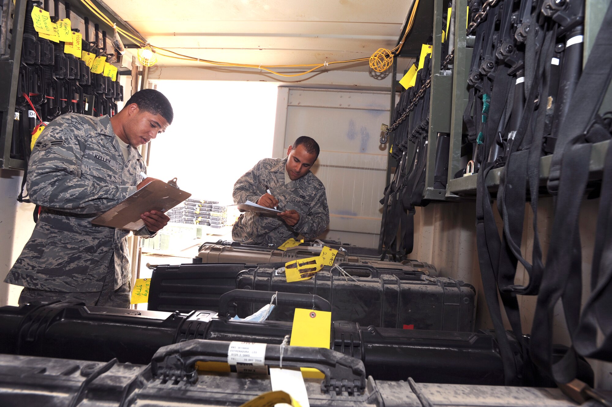 Airman 1st Class Jonathan Kelley and Senior Airman Osvaldo Delhoyo, both supply journeymen for the 379th Logistic Readiness Squadron, perform the daily inventory check of all the weapons in the armory, May 14, 2009, in an undisclosed location in Southwest Asia.  The inventory is performed daily to ensure weapons are not misplaced and that each weapon is assigned to the correct servicemember.  Airman Kelley is native to Crenshaw, Calif. and is deployed from Ellsworth Air Force Base, S.D. while Airman Delhoyo hails from Lawrence, Mass. and is deployed from Tyndell Air Force Base Fla. both in support of Operations Iraqi and Enduring Freedom and Combined Joint Task Force - Horn of Africa. (U.S. Air Force Photo by Staff Sgt. Joshua Garcia/released)