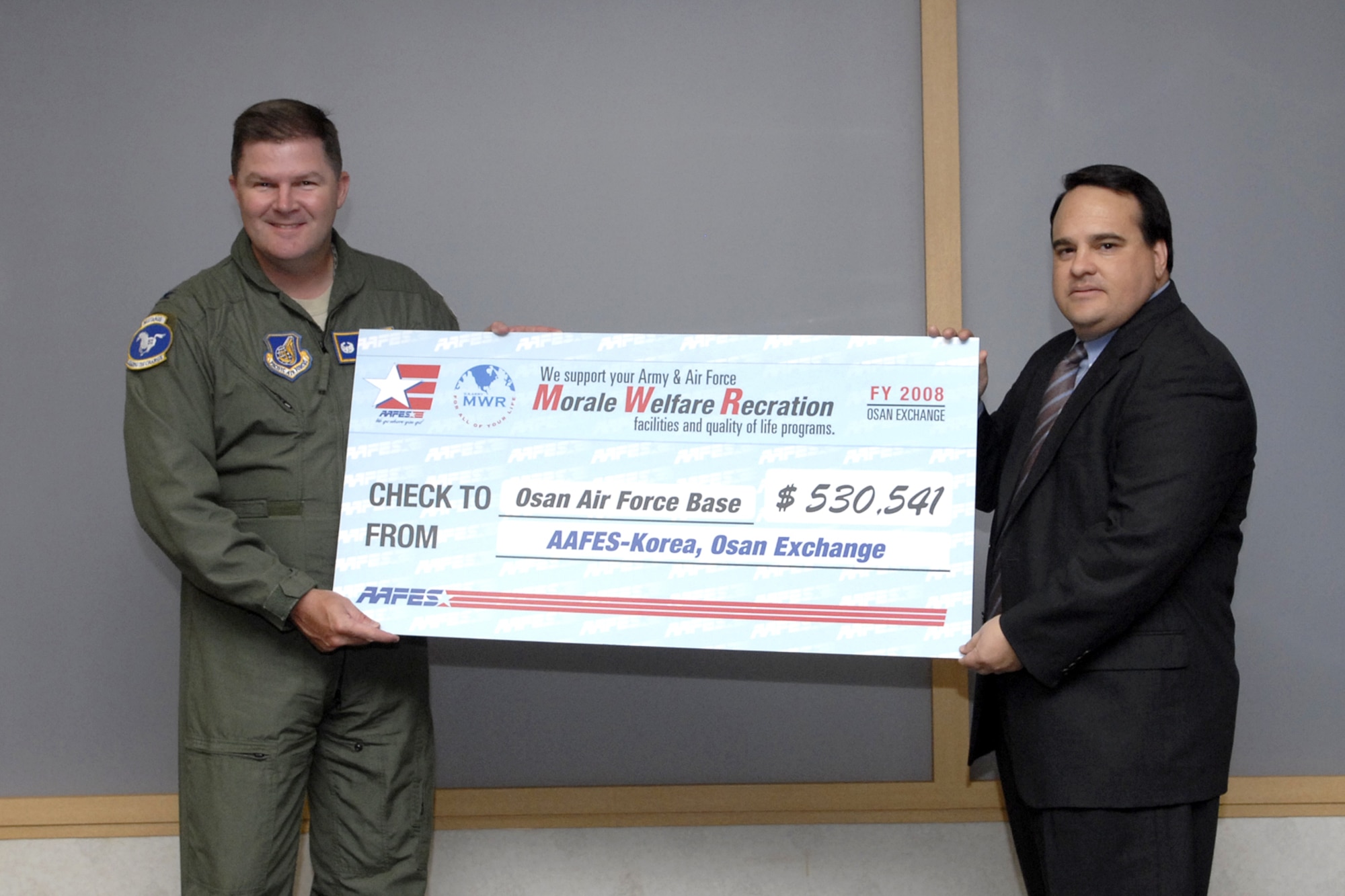 Col. Thomas Deale accepts a morale, welfare and recreation dividend check from Mr. Steve Pena of AAFES-Korea in the amount of $530,541 May 12. Colonel Deale is the 51st Fighter Wing commander. U.S. Air Force Photo/Staff Sgt. Brian Ferguson)