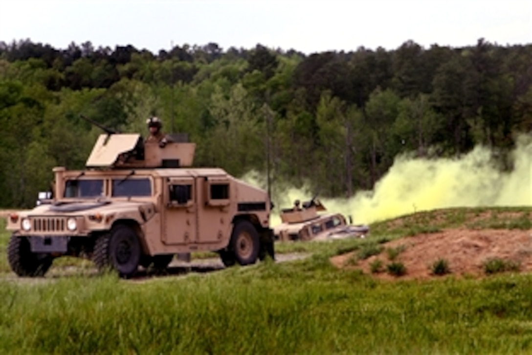 U.S. Marines in Humvees move through the Infantry Platoon Battle Course, May 2, 2009, at the Army National Guard Maneuver Training Center, Fort Pickett, Va. The Marines are part of the Combined Anti-Armor Team, which is assigned to the 2nd Marine Division's 2nd Battalion, 2nd Marine Regiment, Weapons Company.
