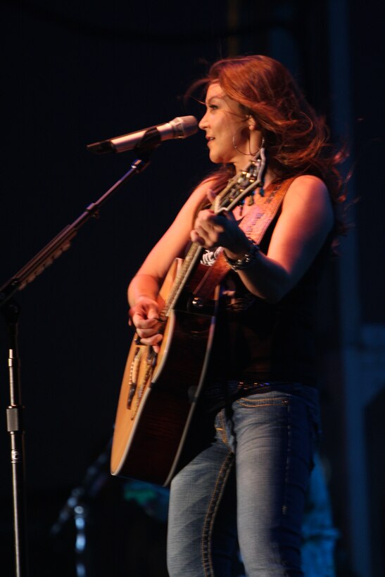 Gretchen Wilson sings a song as she plays her guitar during the fourth annual We Salute You celebration featuring Wilson and the Marine Corps Recruit Depot San Diego Band May 16 at Victory Field. This is the first time she has preformed at the Marine Corps Air Ground Combat Center.