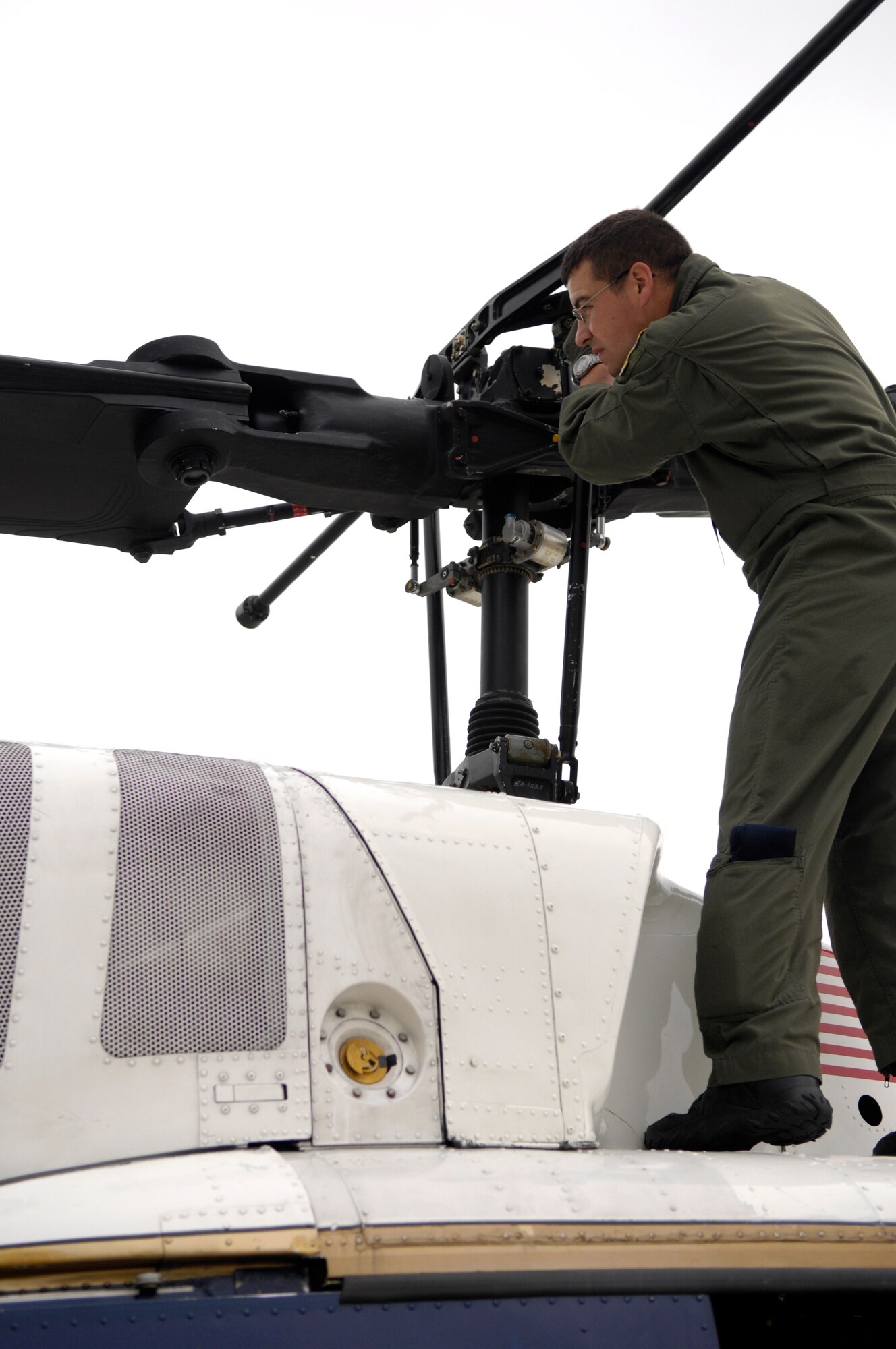 Staff Sgt. Joseph Cox, 1st Helicopter Squadron, performs a pre-flight inspection of the blades of a UH-1N Huey helicopter during the Joint Service Open House May 16 at Andrews Air Force Base, Md. JSOH celebrates military history while showcasing the future capabilities of the world's finest military force. (U.S. Air Force photo by Senior Airman Marleah Miller)
