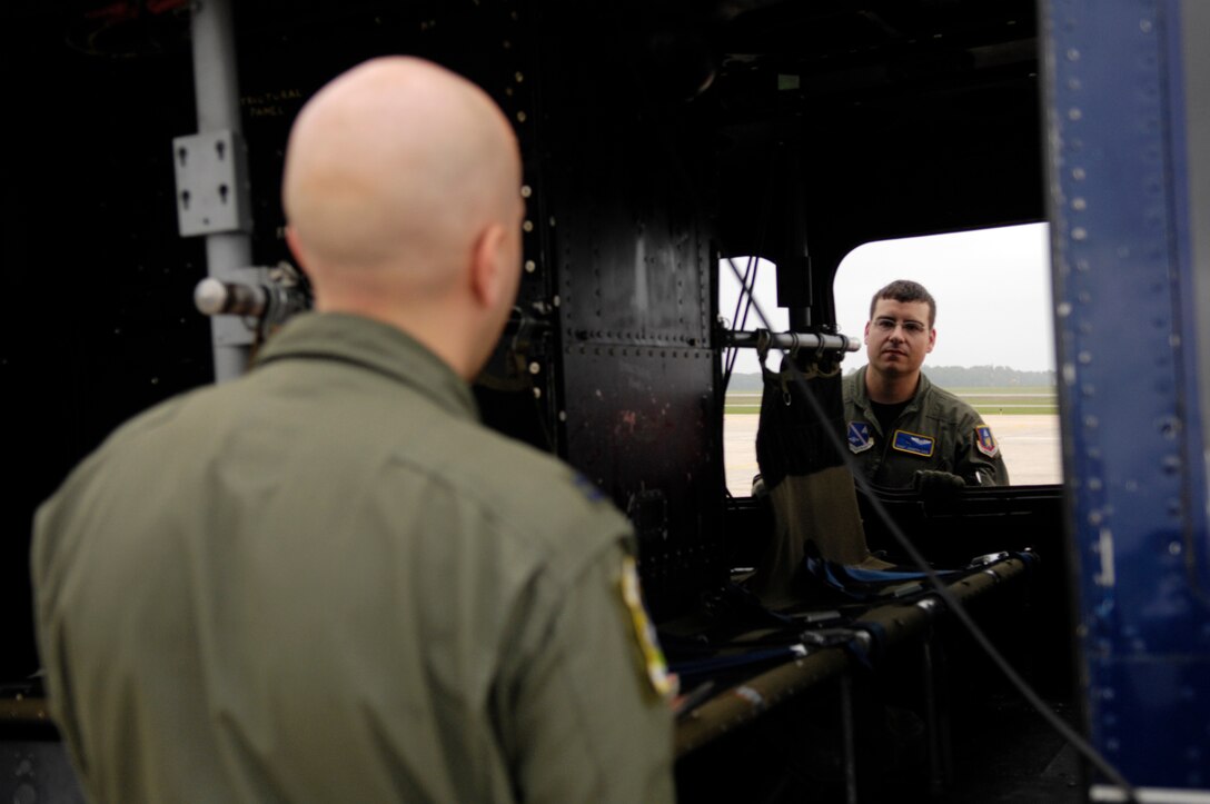 Capt. Nate Jones (left) and Staff Sgt. Joseph Cox, 1st Helicopter Squadron, verify that all pre-flight inspections were performed on the UH-1N Huey helicopter during the Joint Service Open House May 16 at Andrews Air Force Base, Md. JSOH celebrates military history while showcasing the future capabilities of the world's finest military force. (U.S. Air Force photo by Senior Airman Marleah Miller)