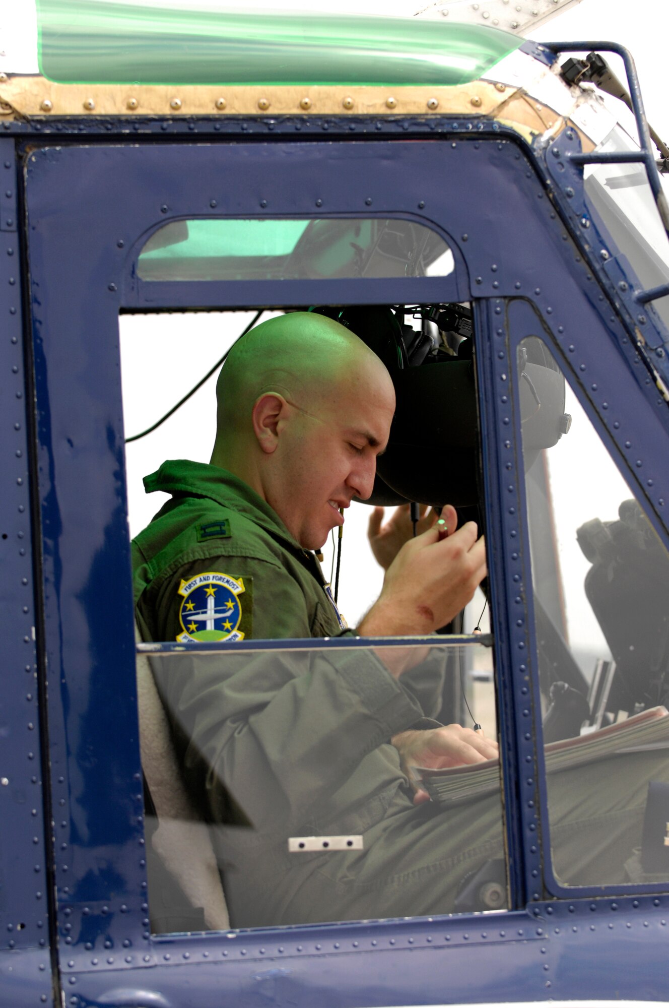 Capt. Nate Jones, 1st Helicopter Squadron pilot, fills out paperwork after returning from a flight during the Joint Service Open House May 16 at Andrews Air Force Base, Md. JSOH celebrates military history while showcasing the future capabilities of the world's finest military force. (U.S. Air Force photo by Senior Airman Marleah Miller)