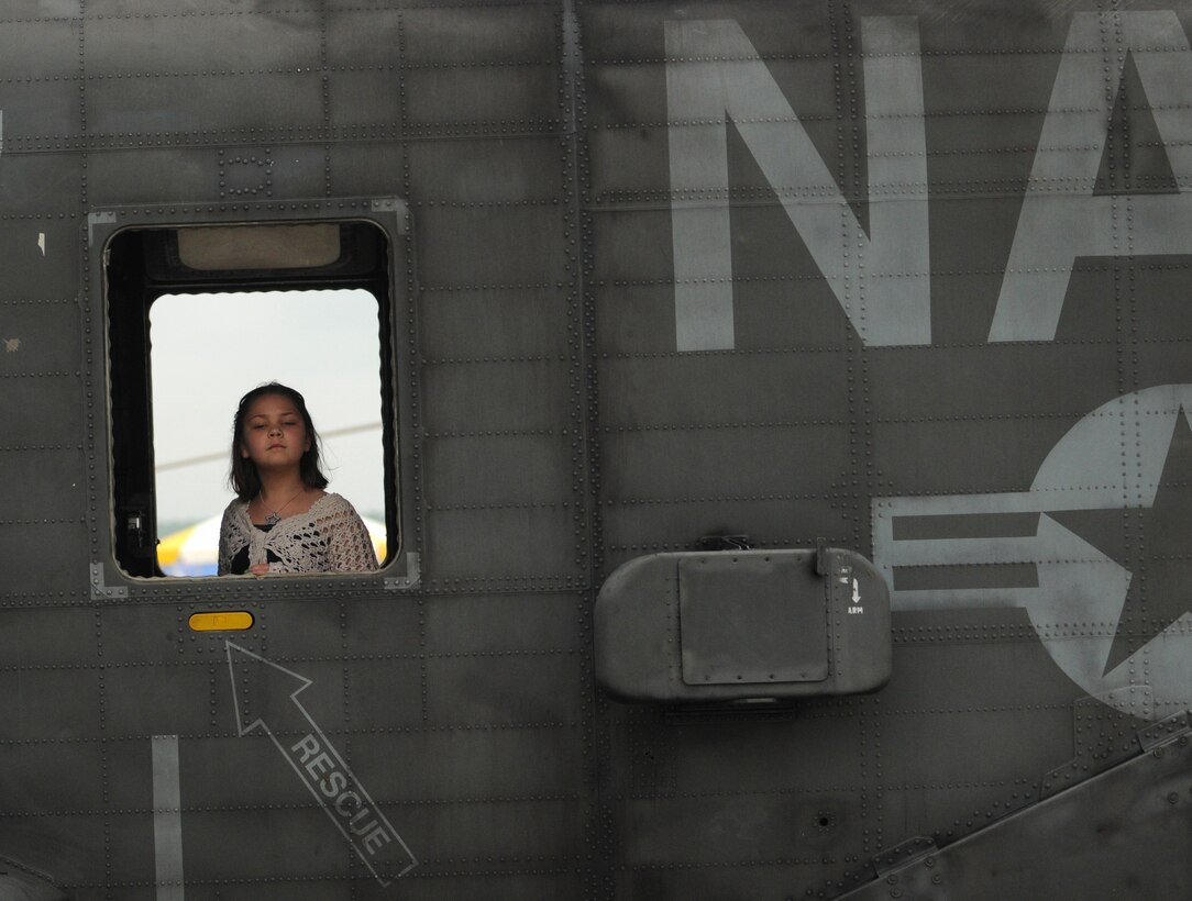 Courtney Corder of Annapolis, Md, peaks out the window of a naval helicopter May 15 at the Joint Service Open House at Andrews Air Force Base, Md.  The annual JSOH allows members of the public an opportunity to meet and interact with the men and women of the Armed Forces. (U.S. Air Force photo by Senior Airman Sean Adams)