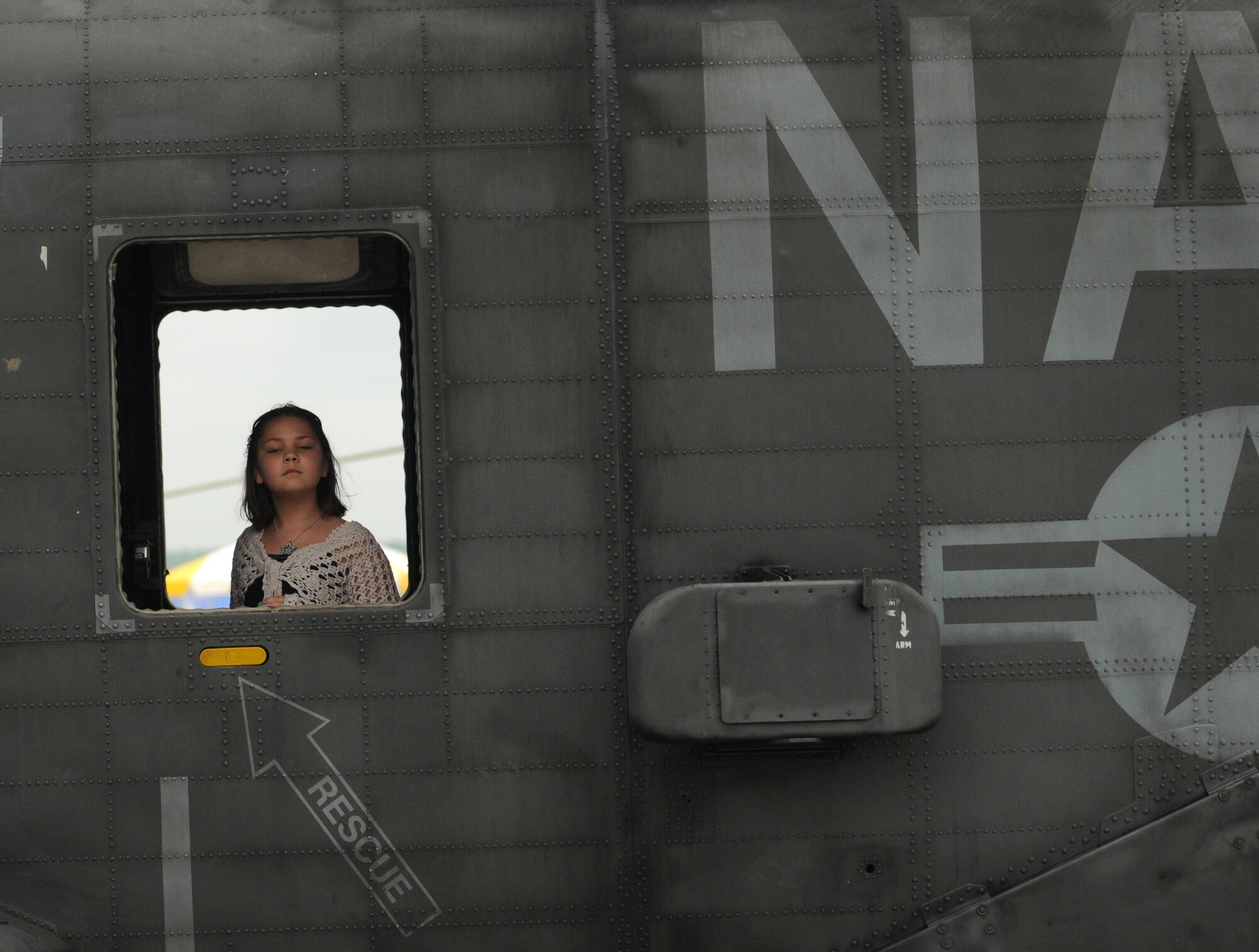 Courtney Corder of Annapolis, Md, peaks out the window of a naval helicopter May 15 at the Joint Service Open House at Andrews Air Force Base, Md.  The annual JSOH allows members of the public an opportunity to meet and interact with the men and women of the Armed Forces. (U.S. Air Force photo by Senior Airman Sean Adams)