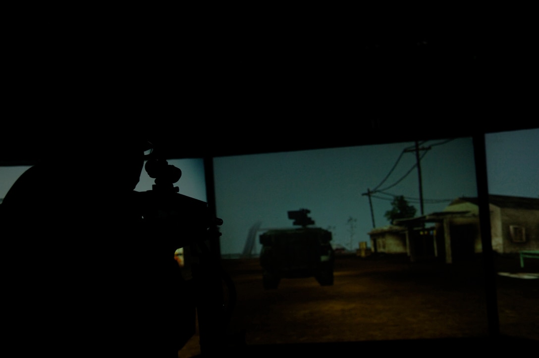 Army Staff Sergeant Gerrol St. John, 80th training Command, fires at an enemy humvee during the Army Virtual Experience May 15 on Andrews Air Force Base, Md. The Army Virtual Experience was one of many displays at the Joint Service Open House. (U.S. Air Force photo by Senior Airman Keyonna Fennell) 