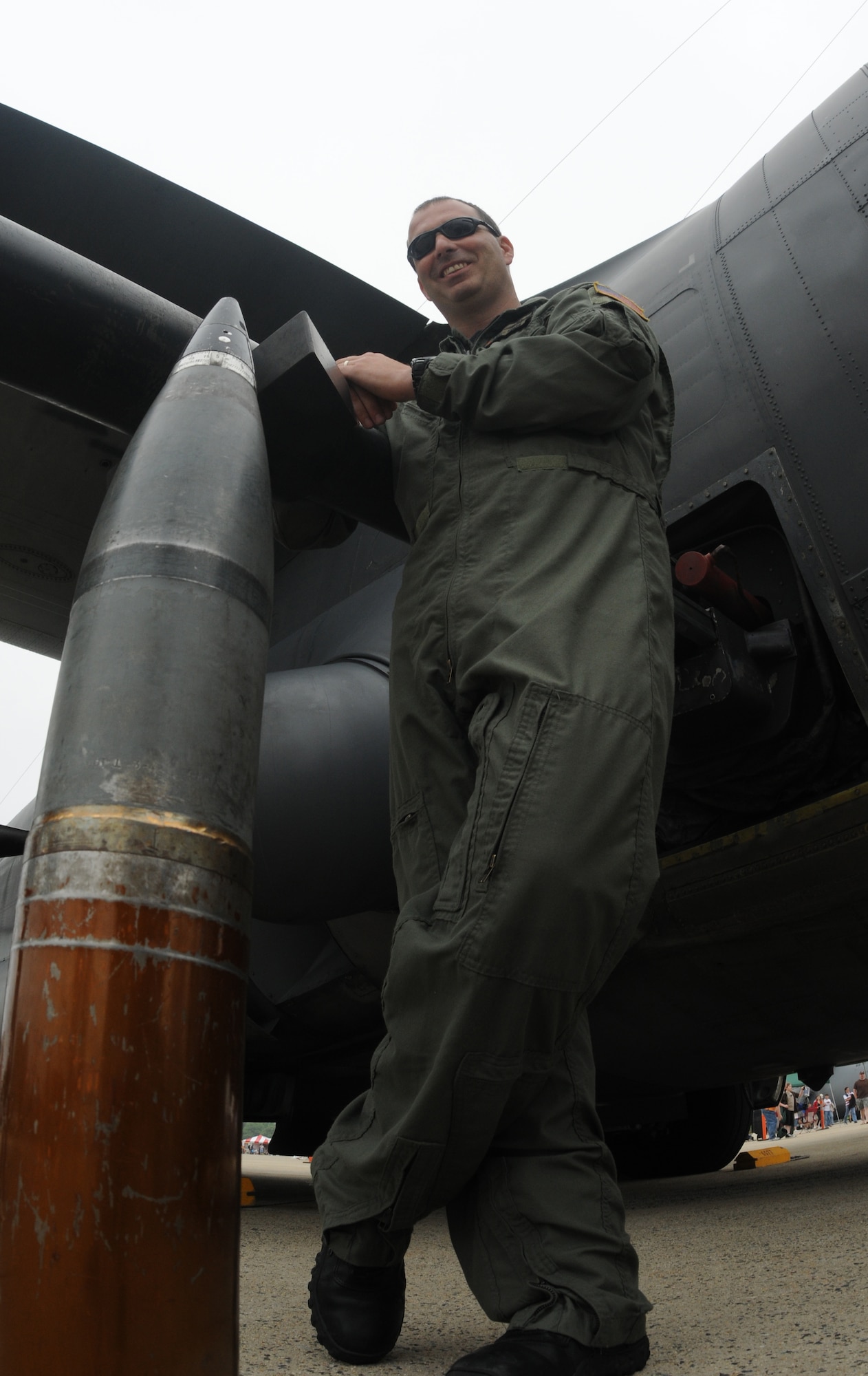 Technical Sgt. Scott Evans, 16th Special Operations Squadron at Hurlburt Field, Fla., stands with an example of a single round of ammunition from his AC-130H Spectre Gunship during the Joint Service Open House May 16 at Andrews Air Force Base, Md.  JSOH offers an opportunity for service members to meet and thank the public for their support and to show them America’s skilled military. (U.S. Air Force photo by Senior Airman Sean Adams)