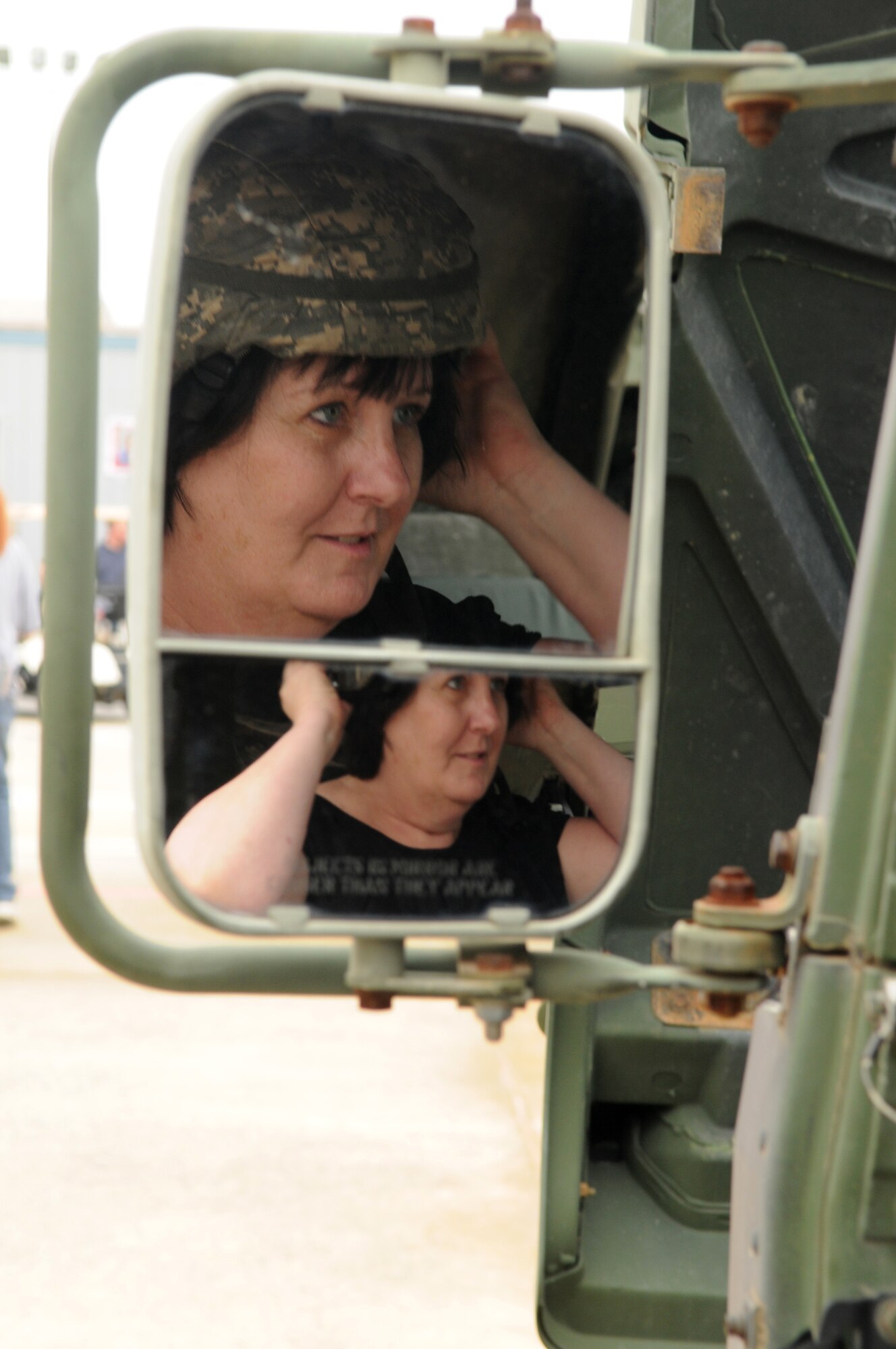 Sheila Grable of Elkridge, Md., tries on a Kevlar helmet during the Joint Service Open House May 16 at Andrews Air Force Base, Md.  JSOH offers an opportunity for service members to meet and thank the public for their support and to show them America’s skilled military. (U.S. Air Force photo by Senior Airman Sean Adams)