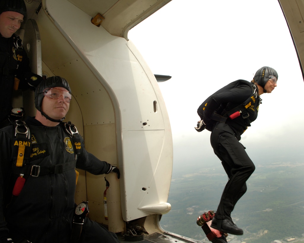 U.S. Army Sgt. First Class Jeffrey Schafar alerts the pilot that Sgt. Rachel Haddon has exited the C-41 Golden Knights aircraft during their demonstration at the Joint Service Open House May 16 at Andrews AFB, Md. The three-day air show offers local community members a closer look at the advanced capabilities of the armed forces. (U.S. Air Force by Senior Airman by Senior Airman Renae Kleckner)