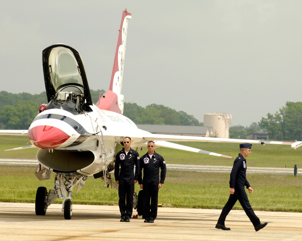 Tech. Sgt. Tom Ellsworth, Crew Chief 1, and Master Sgt. Daniel Lawson, Line Chief, stand at attention while Lt. Col. Greg Thomas, leader of the U.S. Air Force Thunderbirds, as he exits his plane during the Joint Service Open House at Andrews Air Force Base, Md., May 15. The three-day air show offers local community members a closer look at the advanced capabilities of the armed forces. (U.S. Air Force photo by Senior Airman Renae Kleckner)