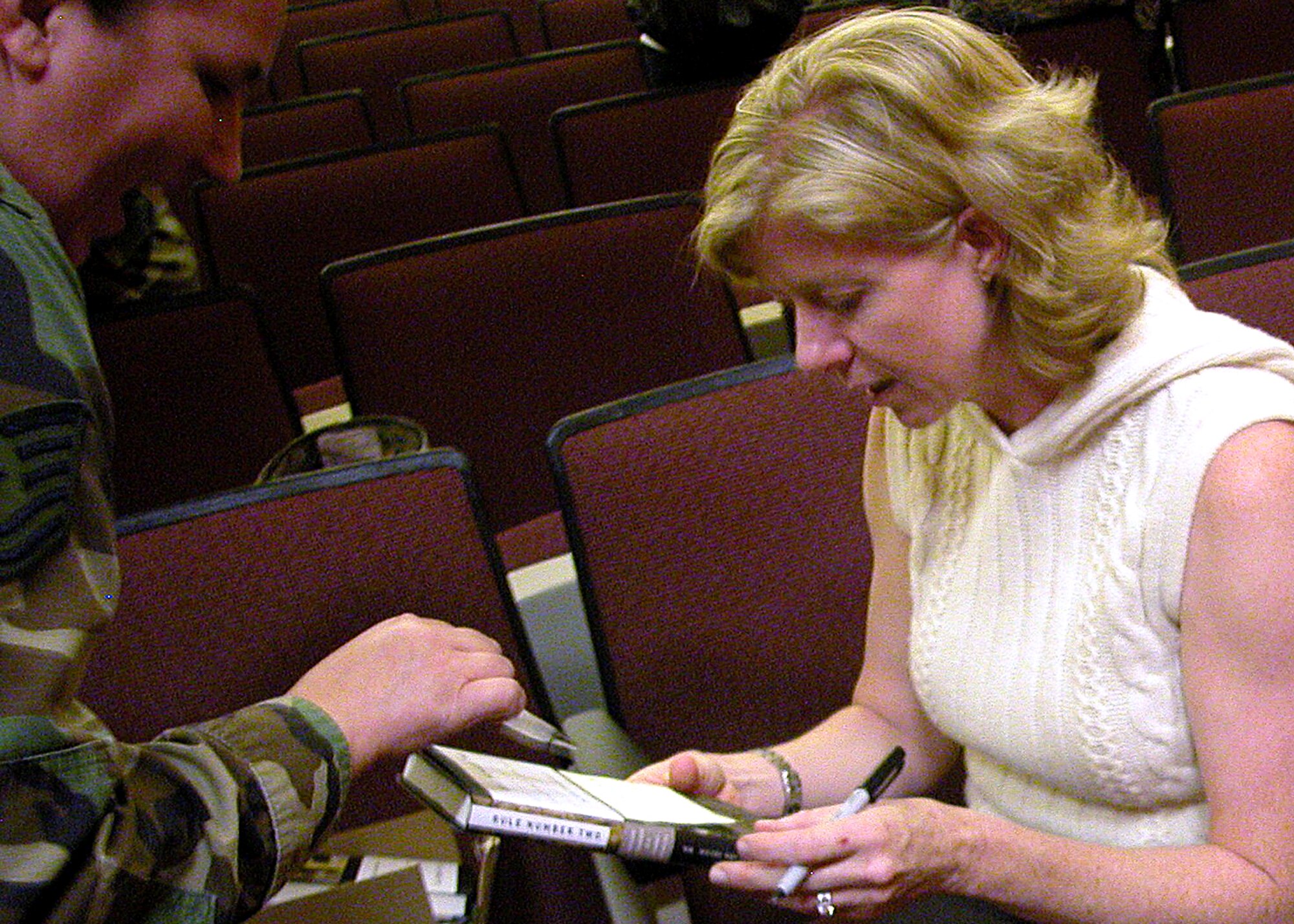 The deputy coordinator for U.S. Navy Combat Stress Control program, Dr. Heidi
Kraft, signs one of her books, Rule Number Two, for a member of the 752d Medical
Squadron. Dr. Kraft, a former naval psychologist with a Marine Corps surgical
company, wrote the book specifically for military medical personnel who are having
problems dealing with combat operational stress.

When Lieutenant Commander Heidi Kraft’s twin son and daughter were fifteen
months old, she was deployed to Iraq. A clinical psychologist in the U.S. Navy,
Kraft’s job was to uncover the wounds of war that a surgeon would never see. She
put away thoughts of her children back home, acclimated to the sound of incoming
rockets and learned how to listen to the most traumatic stories a war zone has to
offer.

Her book RULE NUMBER TWO is a firsthand account of providing comfort amid
the chaos of war and what it takes to endure. (U.S. Air Force photo by Staff Sgt.
David Flaherty)