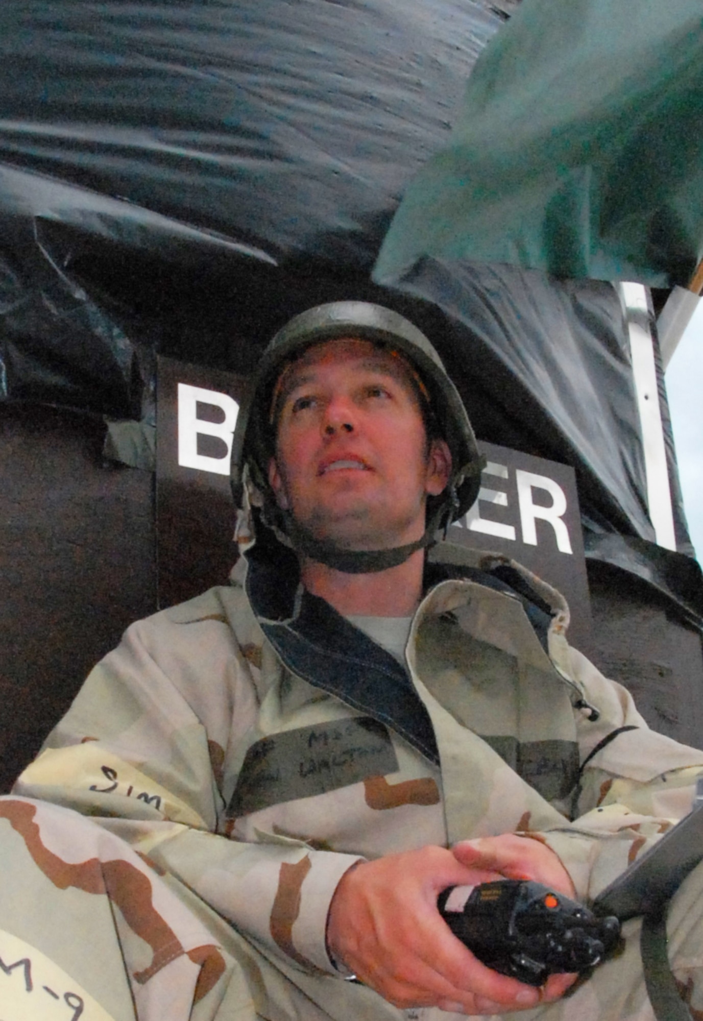 With a watchful eye, Master Sgt. John Walton, 442nd Maintenance Squadron, sits and reflects on his two previous deployments to Bagram Air  Base, Afghanistan, as he admires necessary training for young Airmen going around him during an operational readiness exercise, May 15, at Whiteman Air Force Base, Mo.  His job during the exercise is to keep the shelters ready for them to unwind in on their much needed breaks. The 442nd Maintenance Squadron is part of the 442nd Fighter Wing, an Air Force Reserve Command A-10 Thunderbolt II unit. (US Air Force photo/Staff Sgt. Kent Kagarise)