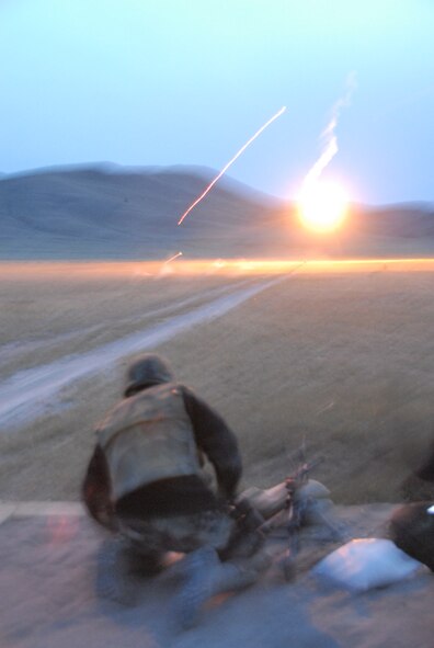 Under the illumination of flares, Security Forces from the 185th Air Refueling Wing, Sioux City, Iowa operate the M-240 and M-249 machineguns during night fire qualification at Fort Harrison, Montana on 13 May 2009.  Tracer rounds aide gunners by allowing him or her to “walk” the fire onto the pop up targets. (US photo by TSgt Brian Cox)