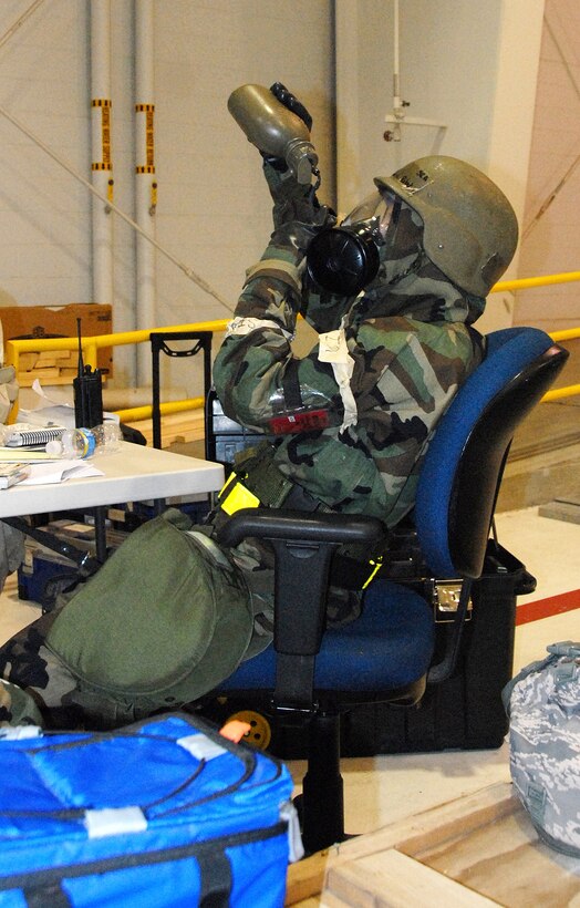 Senior Airman Rebekah McWilliams, 442nd Logistics Readiness Squadron, rehydrates while in mission-oriented-protection-posture four during an operational readiness exercise at Whiteman Air Force Base, Mo., May 15. The 442nd LRS is part of the 442nd Fighter Wing, an Air Force Reserve Command A-10 Thunderbolt II unit. (U.S. Air Force photo/Staff Sgt. Bill Huntington)