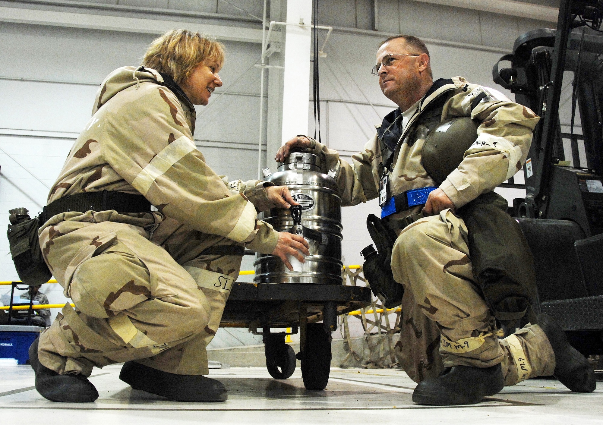 Senior Master Sgt. Shevaun McRoberts, left, 442nd Logistics Readiness Squadron, accepts liquid refreshment offered by 442nd Maintenance Squadron first sergeant, Senior Master Sgt. Tim Storms, during an Operational Readiness Exercise at Whiteman Air Force Base, Mo., May 15. Both squadrons are part of the 442nd Fighter Wing, an Air Force Reserve Command A-10 Thunderbolt II unit. (US Air Force photo/Master Sgt. Bill Huntington)