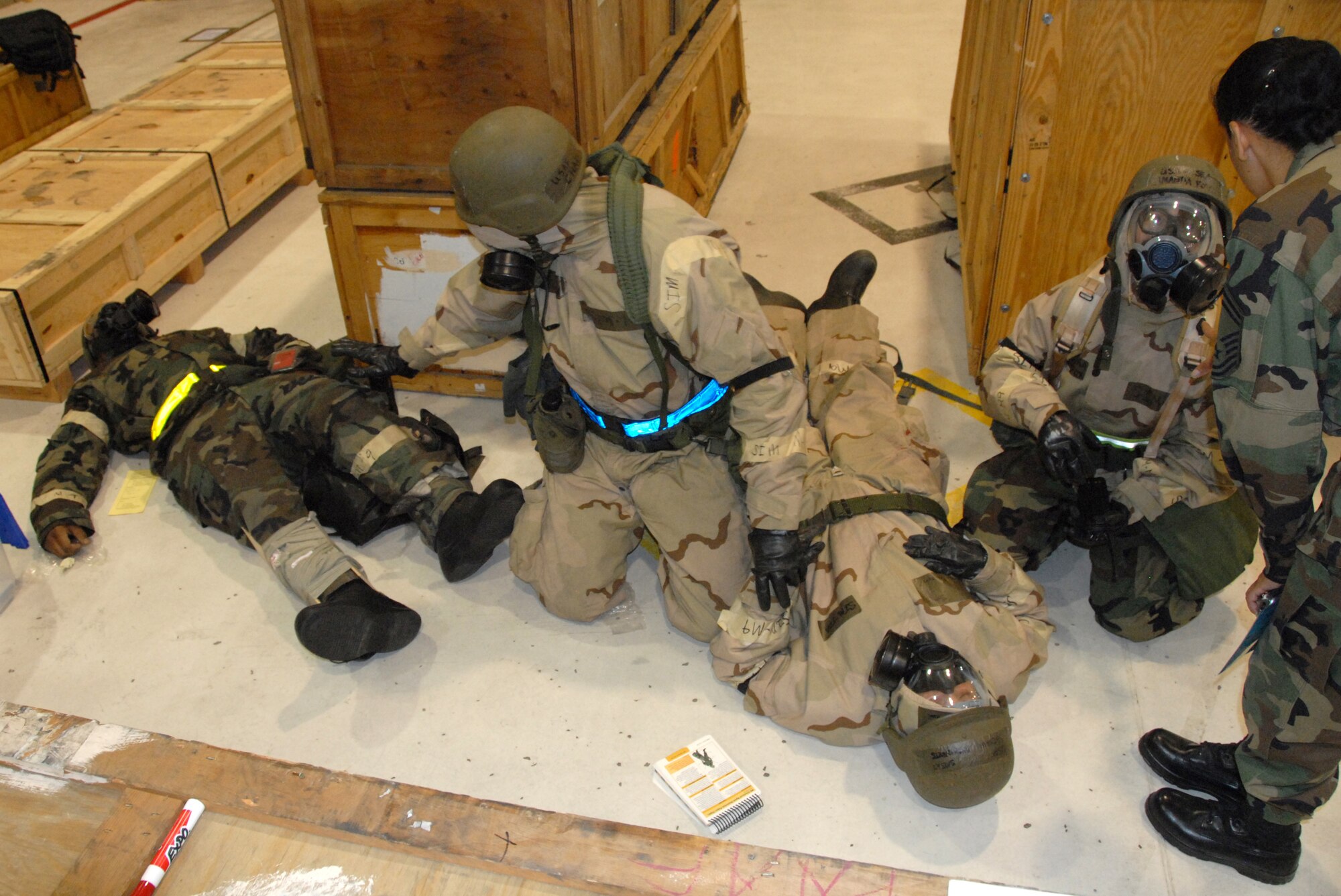 Caught between two casualities, 442nd Logistics Readiness Squadron members, Tech. Sgt. Chad Johnson and Senior Airman Amanda Fox, receive exercise inputs from a 10th Air Force readiness-assistance-visit inspector during an operational readiness exercise at Whiteman Air Force Base, Mo., May 15, 2009. The 442nd LRS is part of the 442nd Fighter Wing, an Air Force Reserve Command A-10 Thunderbolt II unit. (US Air Force photo/Staff Sgt. Kent Kagarise)
