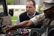 Robert Puhalovich, Director of Business Development for Navistar, looks inside the Strategic Tactical Accessory Repository High Mobility Multipurpose Wheeled Vehicle May 15 while Master Sgt. Kenneth Nero, Marine Corps Systems Command, explains some of the inner workings of the vehicle.The Marine Corps set-up displays all around Navy Pier to allow Chicagoans to come out and see firsthand what the Marine Corps capabilities are.