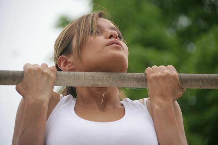 Marine reserve Sgt. July Franco-Bacus, 2nd battalion, 24th Marines, performs the flex-arm hang at Navy Pier May 15. The Marine fitness challenge was a part of the displays and competitions at the pier for the first ever Marine Week. Contestants were given different awards based on the number of pull-ups they could do.