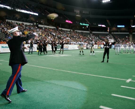 Lt. Col. Sidney McGraw launches the honorary first pass to Chicago Slaughter wide receiver Dontrell Jackson before the Chicago Slaughter-Wisconsin Wolfpack Saturday at the Sears Centre in Hoffman Estates, Ill. McGraw, 45, is the executive officer of Marine Air Control Group 48, the command element of the inaugural Marine Week Chicago. The weeklong event, which concludes today, is an opportunity for Chicago citizens to meet the men and women of the Marine Corps and learn about its history, traditions and value to the nation.