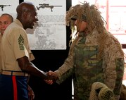 Sergeant Maj. of the Marine Corps Carlton Kent shakes hand with Lance Cpl. Cesar Esparza, with 2nd Battalion, 24th Marines based in Waukegan, Ill. during the pre-dedication Saturday at Navy Pier.