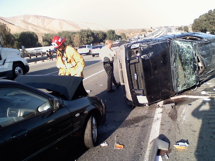 After witnessing a wreck, aftermath seen here, on Interstate 10 West May 17, Combat Center Marines Capt. Thomas Schwabenbauer and Lance Cpl. James Nielsen both stopped to help, rendering first aid to the severely injured driver of the sport utility vehicle. No other motorists were hurt in the accident.