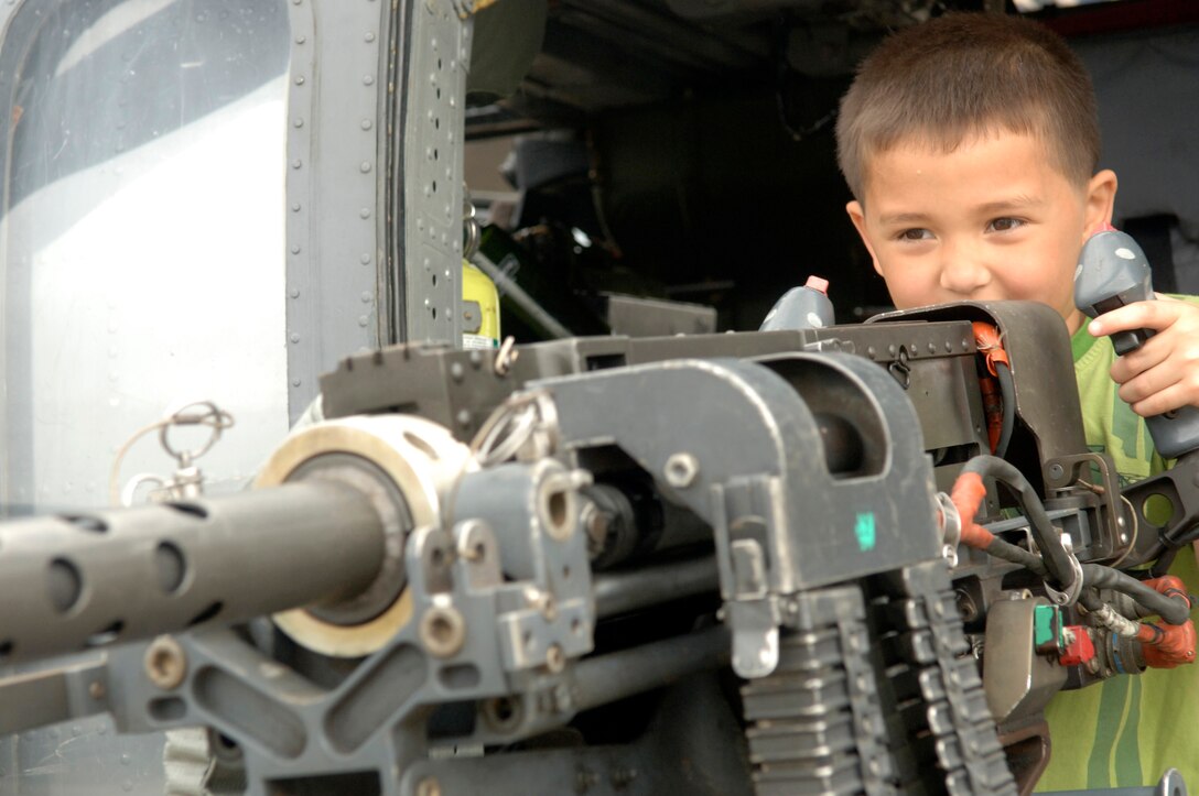 Reese Pickard, dependent of Major Andrew Gamblin, Defense Intelligence Agency Bolling Air Force Base, experiments with the 50 caliber machine gun during Joint Service Open House held at Andrews Air Force base, Md. May 15, 2009.
(US Air Force photo by Senior Airman Keyonna Fennell)