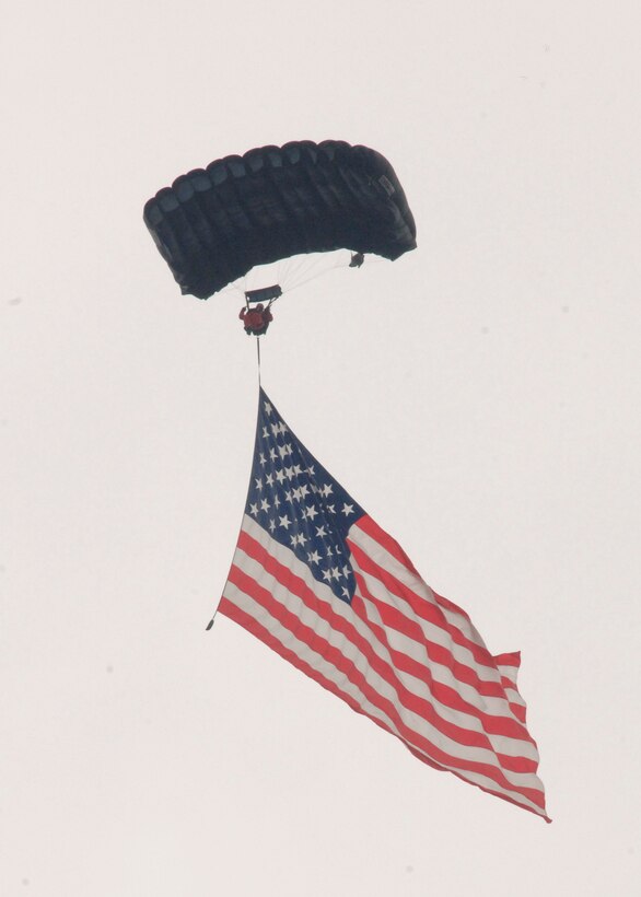 A "Freedom Jumper" parachutes from a plane displaying an American Flag during Joint Service Open House held at Andrews Air Force Base, Md., May 17. Joint Service Open House allows memers of te public an excellent opportunity to meet and interact with the men and women of the Armed Forces. (US Air Force photo by Senior Airman Keyonna Fennell)