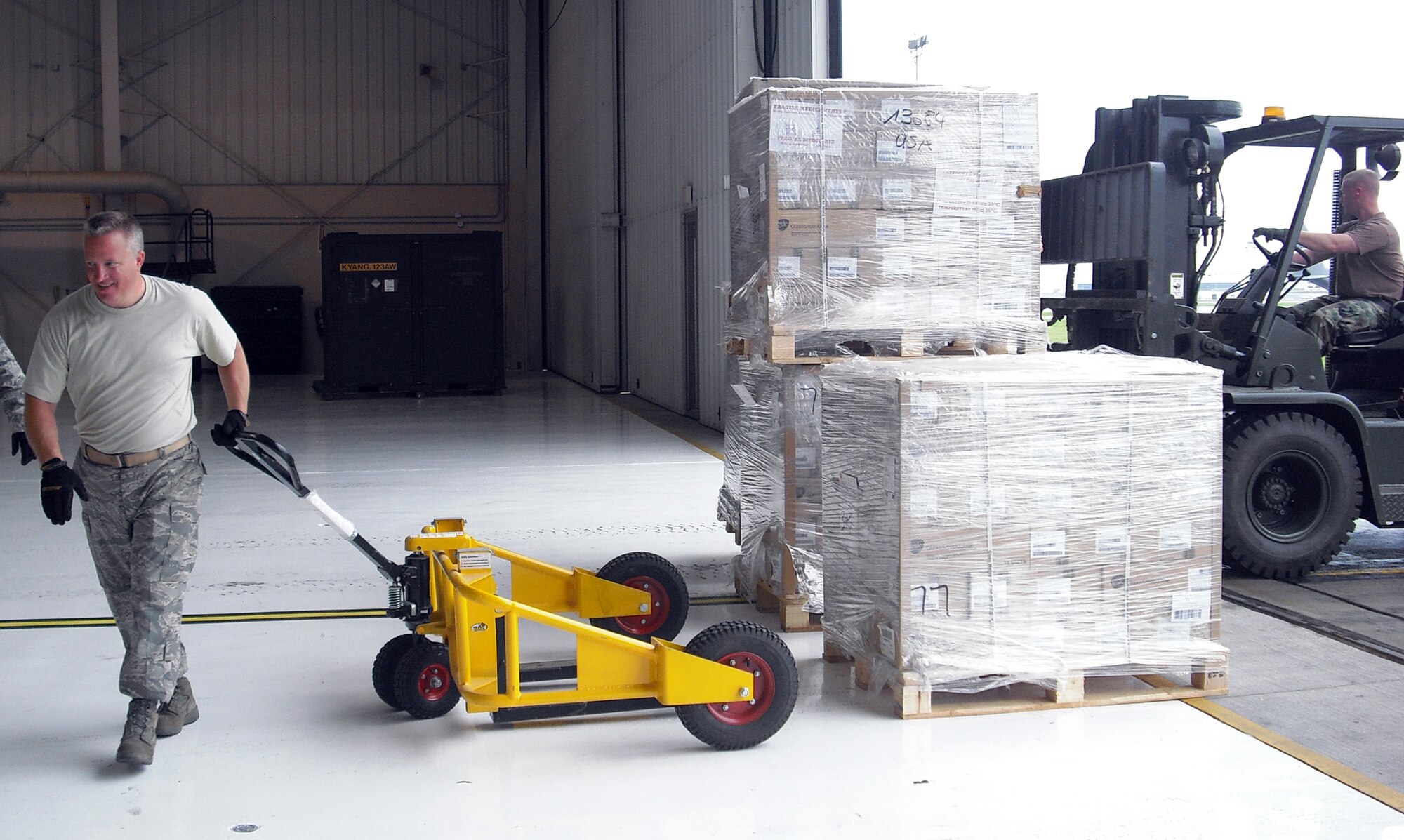 Senior Master Sgt. Wade Zinsmeister moves pallets of personal protective equipment and antiviral medications into the base Fuel Cell Hangar on April 30. The supplies were shipped to the base from the federal Strategic National Stockpile and were repackaged here for distribution to county health departments across the Commonwealth. The effort was part of the state?s response to the potential threat of a Swine Flu pandemic. (KyANG Photo by Maj. Katrina Johnson)