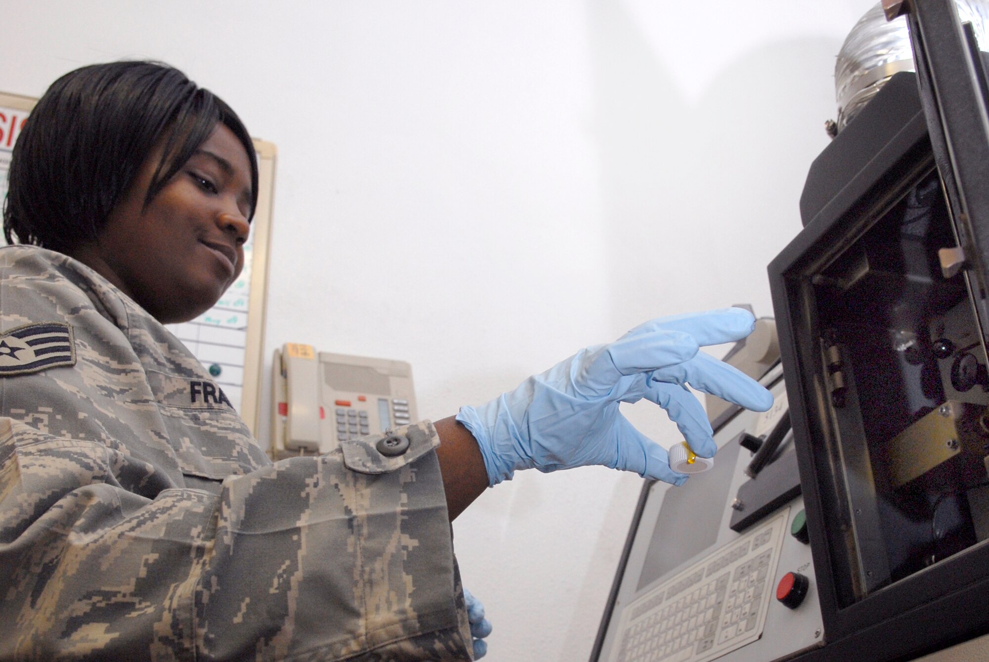 Staff Sgt. Josette Francis, a 379th Expditionary Maintenance Squadron Non-Destructive Inspection (NDI) inspector, places a sample of jet engine oil from a Joint Surveillance Target Attack Radar System (J-STAR) aircraft into a spectrometer to check for contaminating elements or metal fragments which could cause engine damage, May 14, 2009, at an undisclosed location in Southwest Asia.  The oil sample is being checked as part of the Joint Oil Analysis Program (JOAP) which tests oil samples from various locations in the U.S. Central Command's Area of Responsibility to ensure lubricants are performing properly.  Sergeant Francis hails from Washington, D.C. and is deployed from Aviano Air Base, Italy in support of Operations Iraqi and Enduring Freedom and Combined Joint Task Force - Horn of Africa.  (U.S. Air Force photo/Senior Airman Andrew Satran/released)