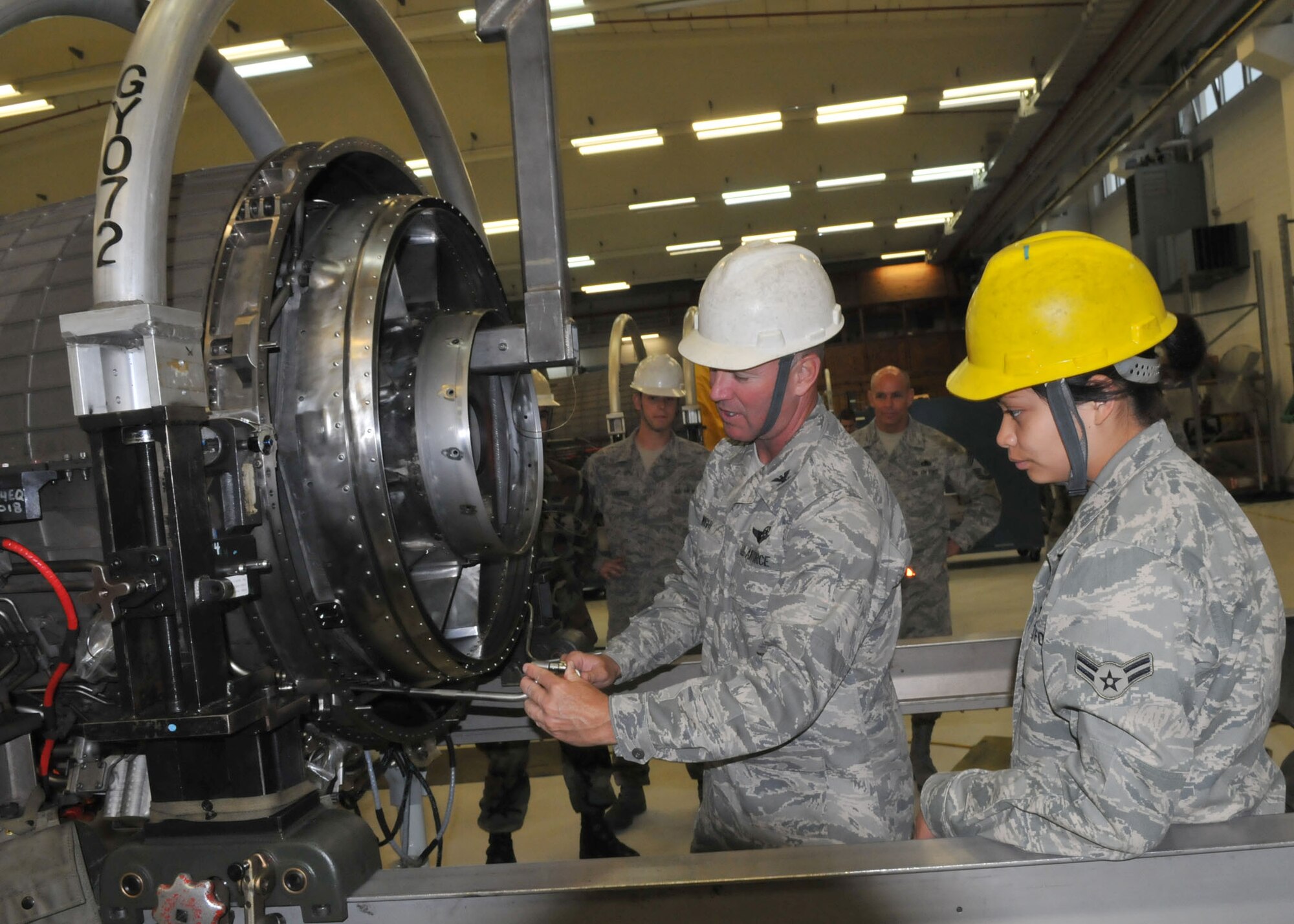 SPANGDAHLEM AIR BASE, Germany –Col. Lee T. Wight, 52nd Fighter Wing commander, helps with a turbine installation as Airman First Class Anna Lipatan, 52nd Component Maintenance Squadron Propulsion Flight, watches. Colonel Wight spent time learning about Airman Lipatan’s job as part of the Commander’s Shadow program May 12, 2009. (U.S. Air Force photo by Airman 1st Class Nicholas Wilson)