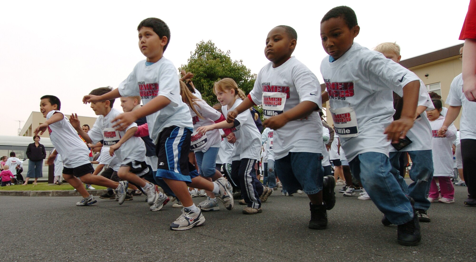 YOKOTA AIR BASE, Japan -- Participants in the one-mile run at the Armed Forces Kids Run 2009 vie for the lead straight from the start May 16 on the base's west side. More than 100 children took part in the 24th anniversary of the run held at military installations worldwide. It's designed to give children a fun and safe way to exercise. (U.S. Air Force photo/Master Sgt. Matt Summers)