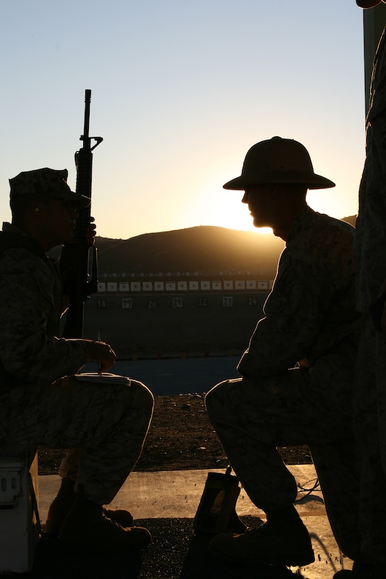 Sgt. Scott M. Furseth, a combat marksmanship trainer with the Carlos Hathcock Range Complex aboard Marine Corps Air Station Miramar, offers advice to Lance Cpl. Inocencio Torres, an administrative clerk with Headquarters and Headquarters Squadron, MCAS Miramar, during the table one section of rifle qualification at the range.  Combat marksmanship trainers help supervise the coaches and shooters in addition to relaying messages to the tower.   (U.S. Marine Corps photo by Lance Cpl. Christopher O'Quin) (Released)