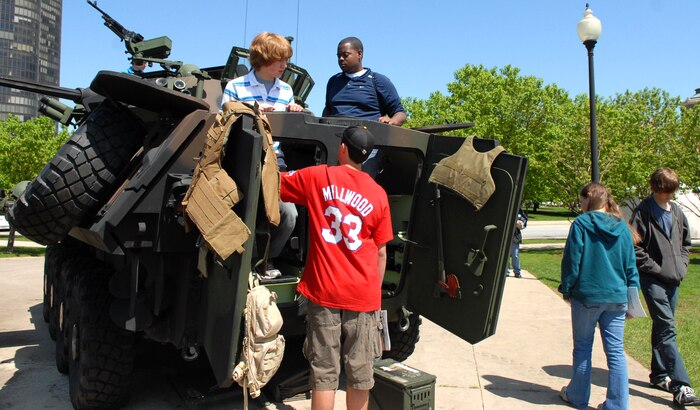 Citizens of Chicago view and climb aboard a light armored vehicle at the vehicle static display outside of Navy Pier, Chicago, during Marine week May 17.