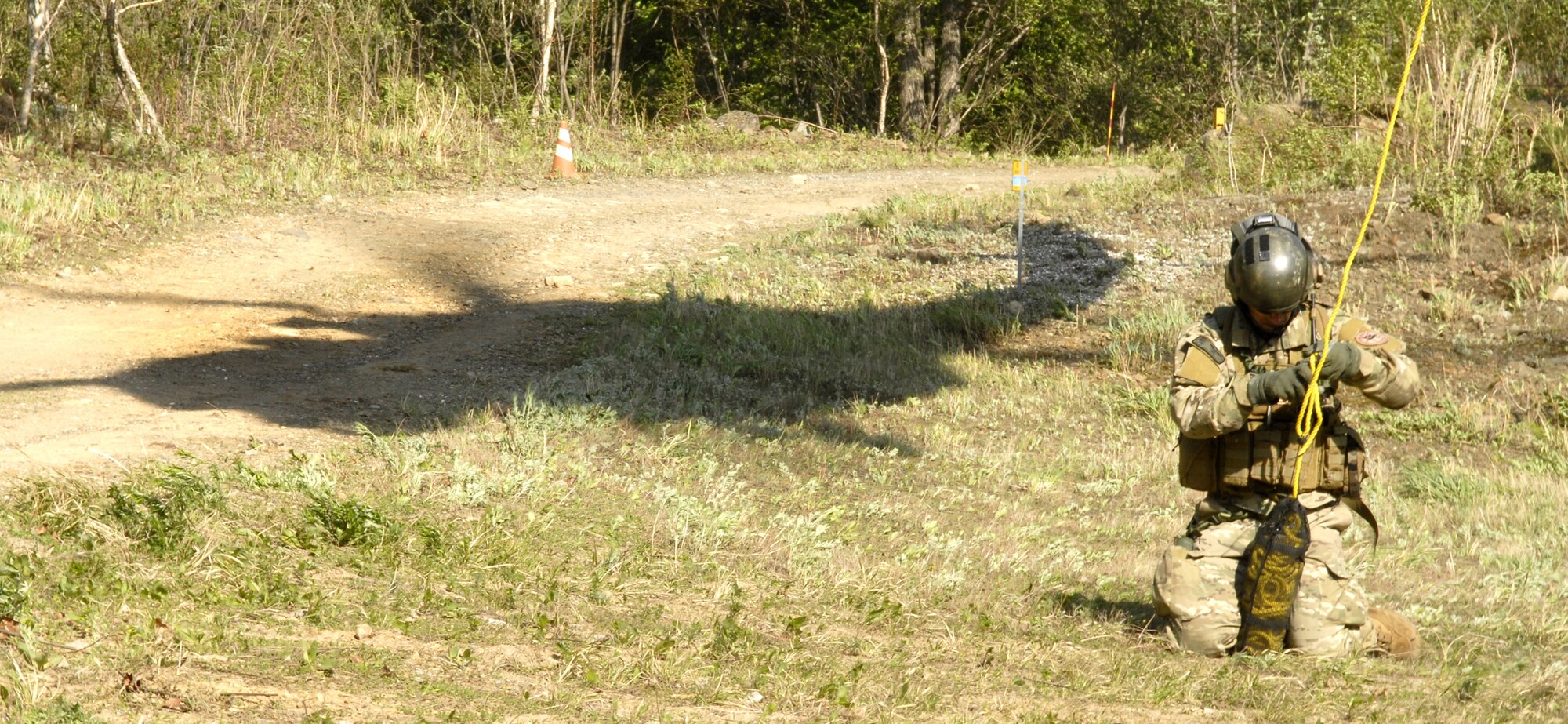 A pararescueman from the 31st Rescue Squadron, Kadena AB Japan, unlaches a weight from the rope used by the pararescuemen to take up injured, non-ambulatory survivors into a helicopter during exercise Pacific Thunder 09-01 hosted by Osan AB, Republic of Korea May 13. The Airmen were injured after a C-130 crashed in a simulated mass casualty exercise leaving two airmen non-ambulatory and four severely injured.  The overall goal of the exercise is to practice integrating all airframes necessary to rescue a downed Airman in a medium to high threat environment.   Pacific Thunder is the largest combat search and rescue exercise ever for Pacific AIr Force.   (U.S. Air Force photo/Senior Airman Stephenie Wade)