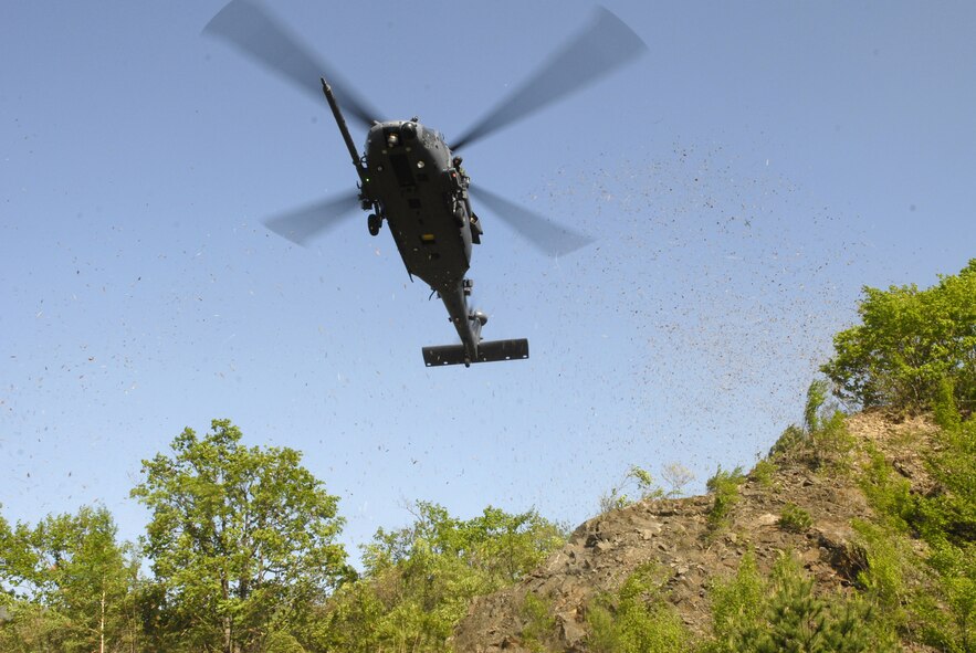 A HH-60G Pavehawk arrives from over the hills of Pil Sung park, Republic of Korea with pararescuemen from the 31st Rescue Squadron, Kadena AB Japan to pick up six severely injured Airmen during the exercise Pacific Thunder 09-01 hosted by Osan AB May 13. The Airmen were injured after a simulated C-130 crash  in a mass casualty exercise leaving two airmen non-ambulatory and four severely injured.   The overall goal of the exercise is to practice integrating all airframes necessary to rescue a downed Airman in a medium to high threat environment.   Pacific Thunder 09-01 is Pacific Air Force?s only exercise devoted to combat search and rescue. (U.S. Air Force photo/Senior Airman Stephenie Wade)