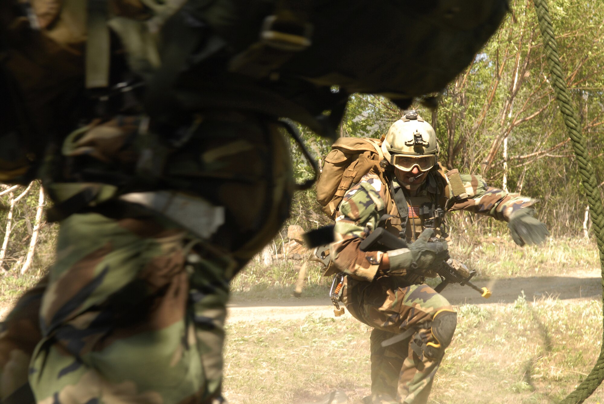 A pararescuemen  runs to assist an injured Airmen after a  C-130 crash in a simulated mass casualty during the exercise Pacific Thunder 09-01 hosted at Osan AB Republic of Korea, May 13. The crash left two Airmen non-ambulatory and four severely injured.  The overall goal of the exercise is to practice integrating all airframes necessary to rescue a downed Airman in a medium to high threat environment.   Pacific Thunder is the largest combat search and rescue exercise ever for Pacific Air Force.(U.S. Air Force photo/Senior Airman Stephenie Wade)