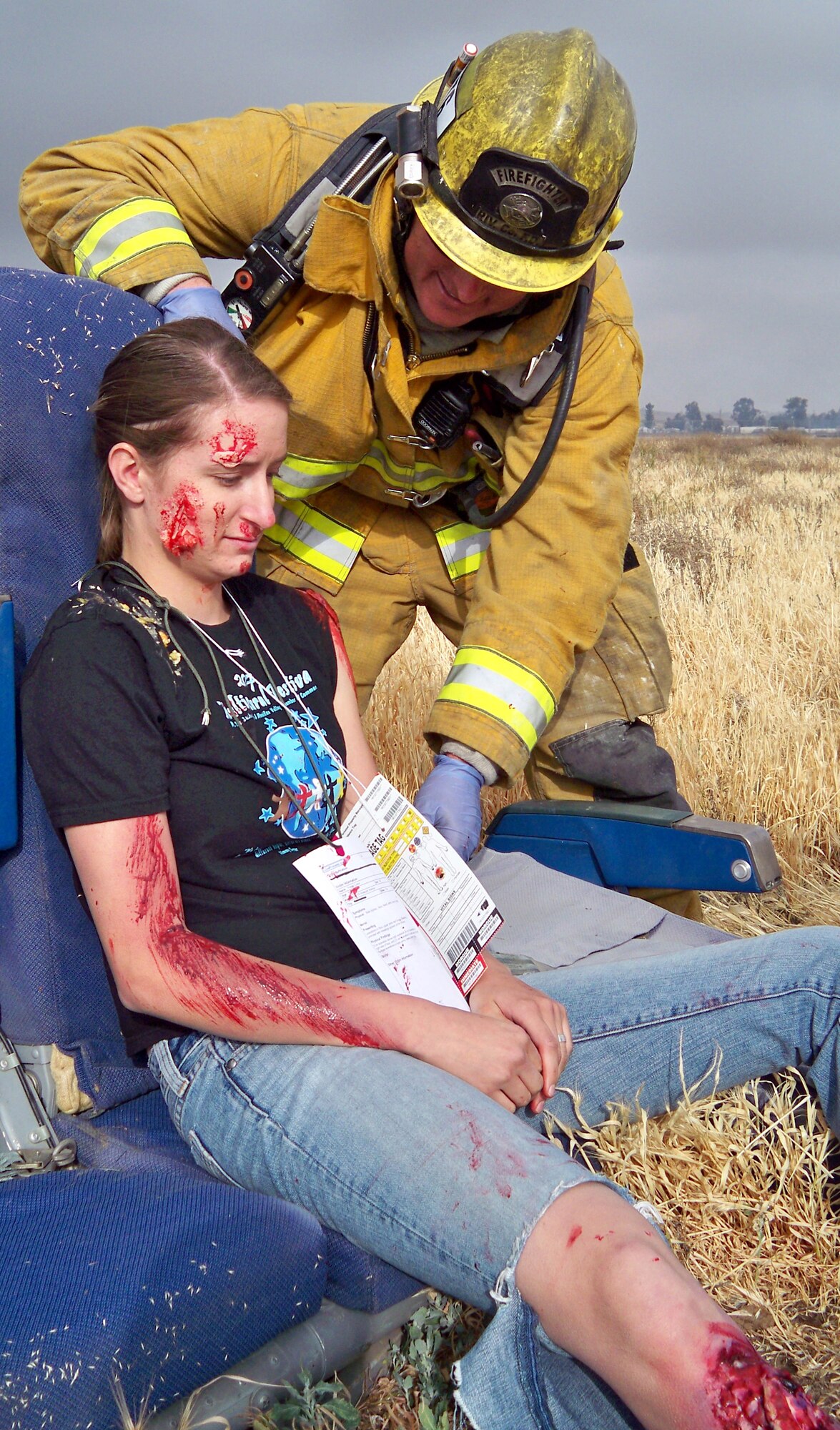 Corey Trujillo, California Department of Forestry firefighter assesses the injuries of Tawnee Roth, a volunteer patient from an EMT class at Mt. San Jacinto College, during a recent crash exercise. (U.S. Air Force photo by MSgt. Linda E. Welz)