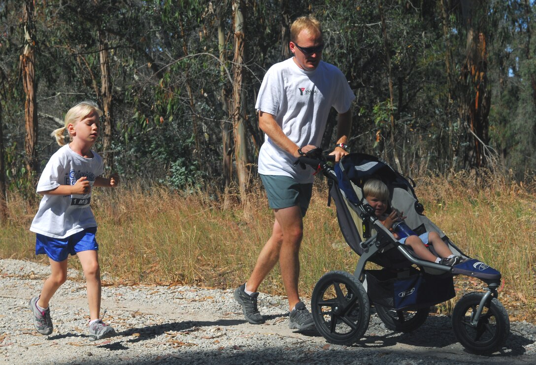 VANDENBERG AIR FORCE BASE, Calif. -- Staff Sgt. Mickey Sederburg of the 533rd Training Squadron runs with his daughter, Annika, and son, Jonah, during America's Armed Forces Kids Run here May 16. The Armed Forces Kids Run was one of many events in celebration of Armed Forces Day. (U.S. Air Force photo/Senior Airman Christopher Hubenthal)
