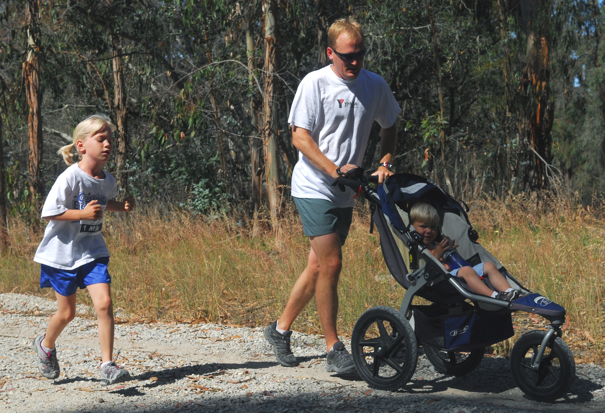 VANDENBERG AIR FORCE BASE, Calif. -- Staff Sgt. Mickey Sederburg of the 533rd Training Squadron runs with his daughter, Annika, and son, Jonah, during America's Armed Forces Kids Run here May 16. The Armed Forces Kids Run was one of many events in celebration of Armed Forces Day. (U.S. Air Force photo/Senior Airman Christopher Hubenthal)