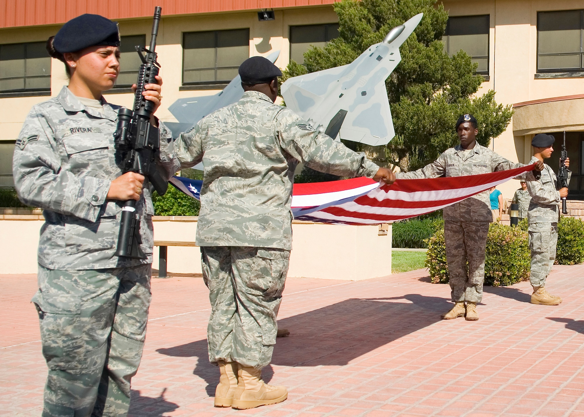 Members of the 95th Security Forces Squadron honor guard fold the flag during a retreat ceremony at the Air Force Flight Test Center Headquarters May 15. The 95th SFS hosted the ceremony. (U.S. Air Force photo/Mike Cassidy)