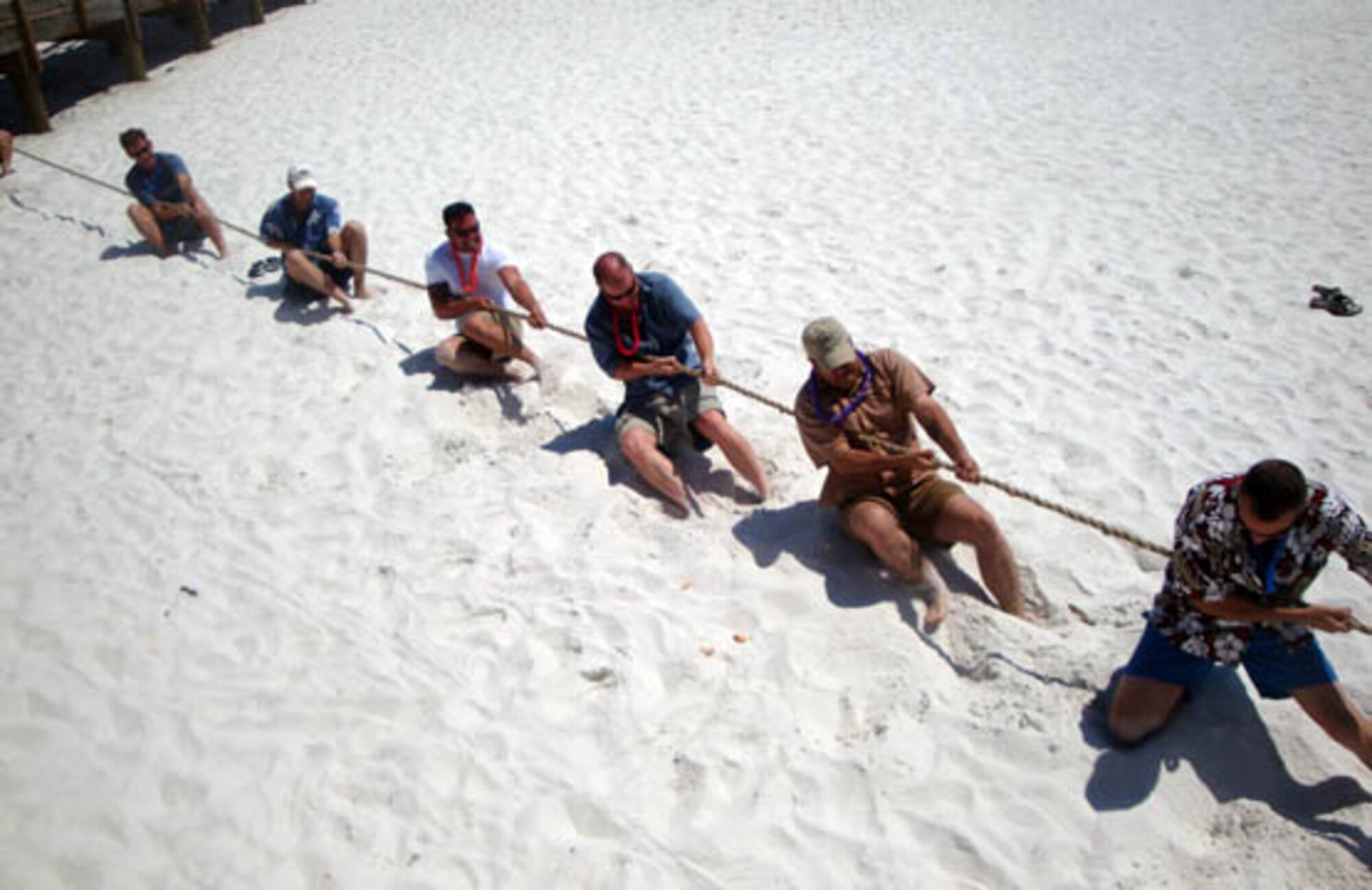 Members of the 84th Test and Evaluation Squadron, Eglin Air Force Base, Fla. and 706th Fighter Squadron Detachment 1, Hurlburt Field, Fla. compete in a tug-o-war during the New Old Squadron Luau the last weekend of April. The day brought members of both U.S. Air Force Reserve units together to celebrate the heritage of the 84th TES. The newly-reactivated squadron kept the name and Fighting Wizards mascot, but unlike the old unit which tested radar and electronic countermeasures systems, it is now integrated across the full spectrum of the 53rd Wing at Eglin AFB. After sifting through photos of the old 84th TES having a luau, Lt. Col. John Breazeale, current 84th TES commander, decided to have one of his own as a tribute to the squadron's past. The event also included a 1.5-mile run, volleyball, frisbee, hulahooping, sunbathing and a pig roast.