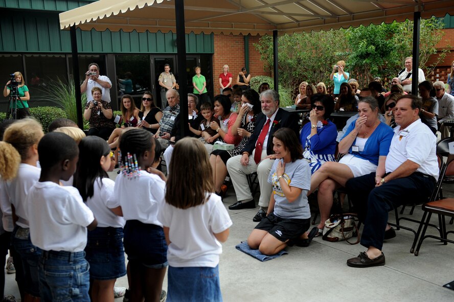 MOODY AIR FORCE BASE, Ga. -- Members of Ms. Dean’s kindergarten class at Sallas Mahone Elementary School in Valdosta, Ga., sing, “I’m Proud to be an American,” as members of the Capt. Scott Craven family watch during the Scott Craven Café dedication ceremony May 15. (U.S. Air Force photo by Senior Airman Gina Chiaverotti)