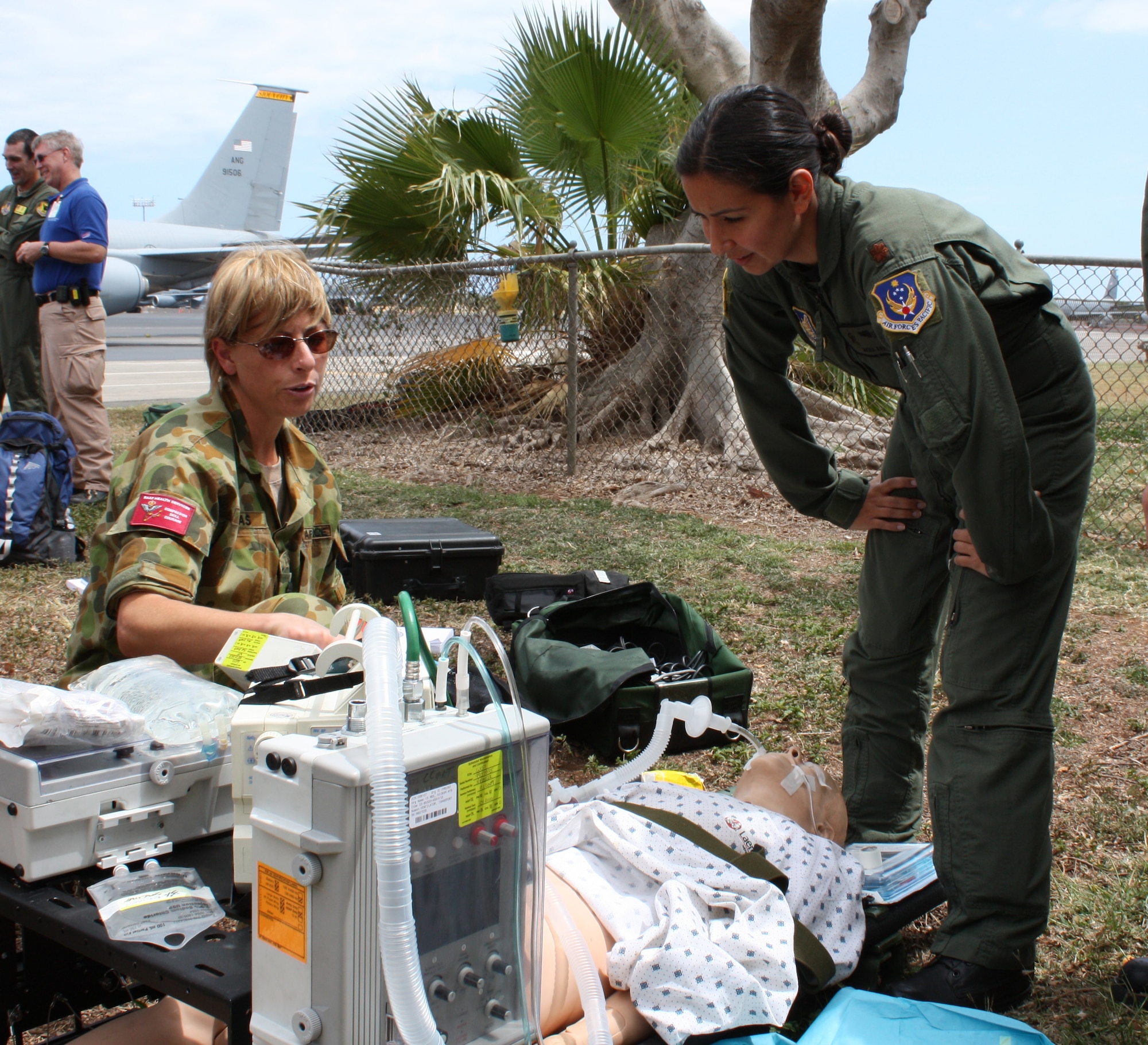 Wing Commander Alexandra Douglas (left), a critical-care anesthesiologist with the Royal Australian Air Force and Major (Dr.) Maria Angles, validating flight surgeon for Theater Patient Movement Requirements Center-Pacific, train during the Joint Medical Attendant Transport Team training course held at Hickam Air Force Base, Hawaii May 11-15. The JMATT course, hosted by Thirteenth Air Force's Theater Patient Movement Requirements Center-Pacific, the aeromedical evacuation regulating organization for U.S. Pacific Command, focused on the aeromedical evacuation of critical care patients and equipment proficiency skills. (U.S. Air Force photo/ Tech. Sgt. Kerry Jackson)