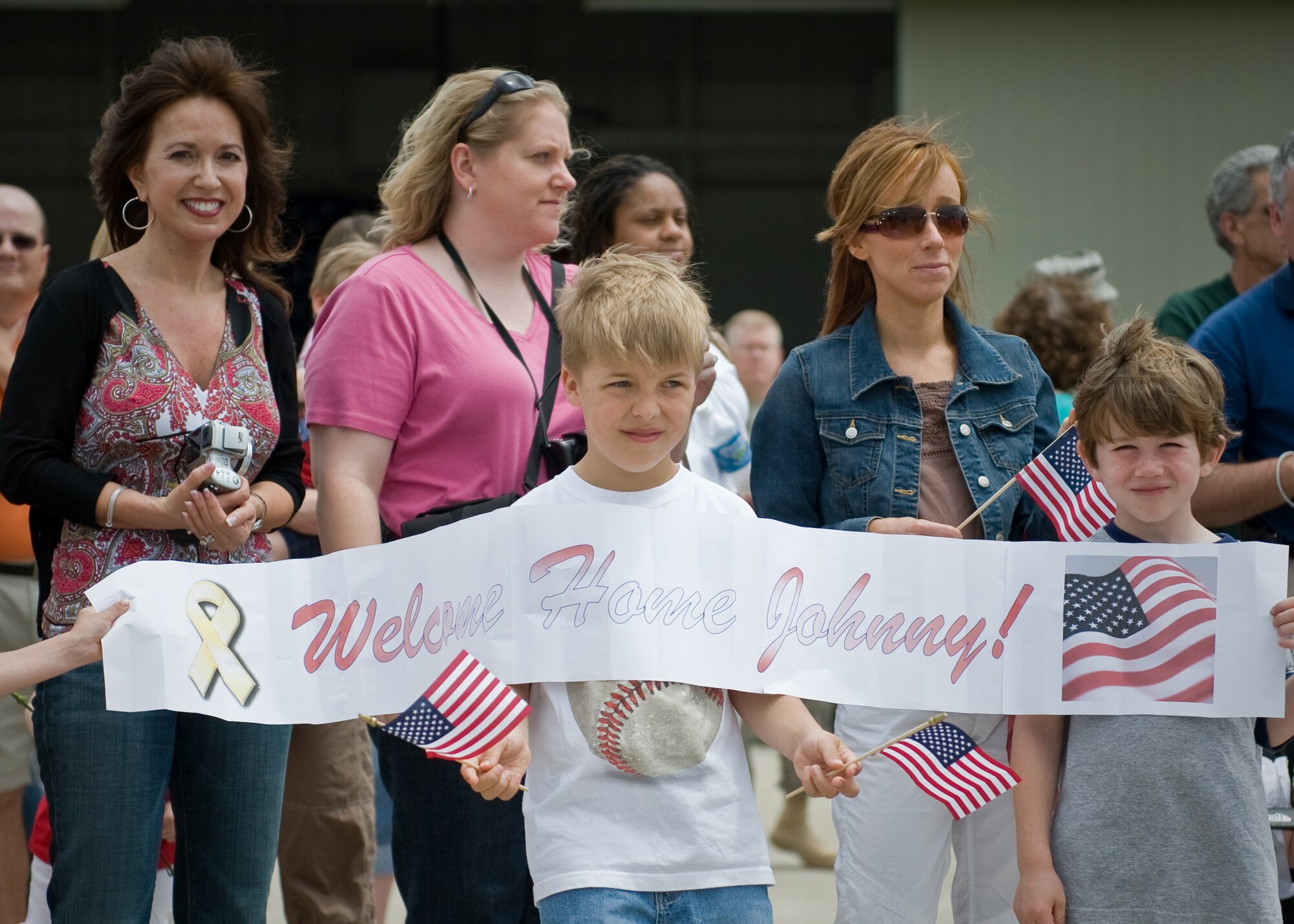 Family members wait near the Kentucky Air Guard Base flightline May 16 for the return of Airmen who were deployed to Afghanistan in mid-March. (USAF photo by Capt. Dale Greer.)