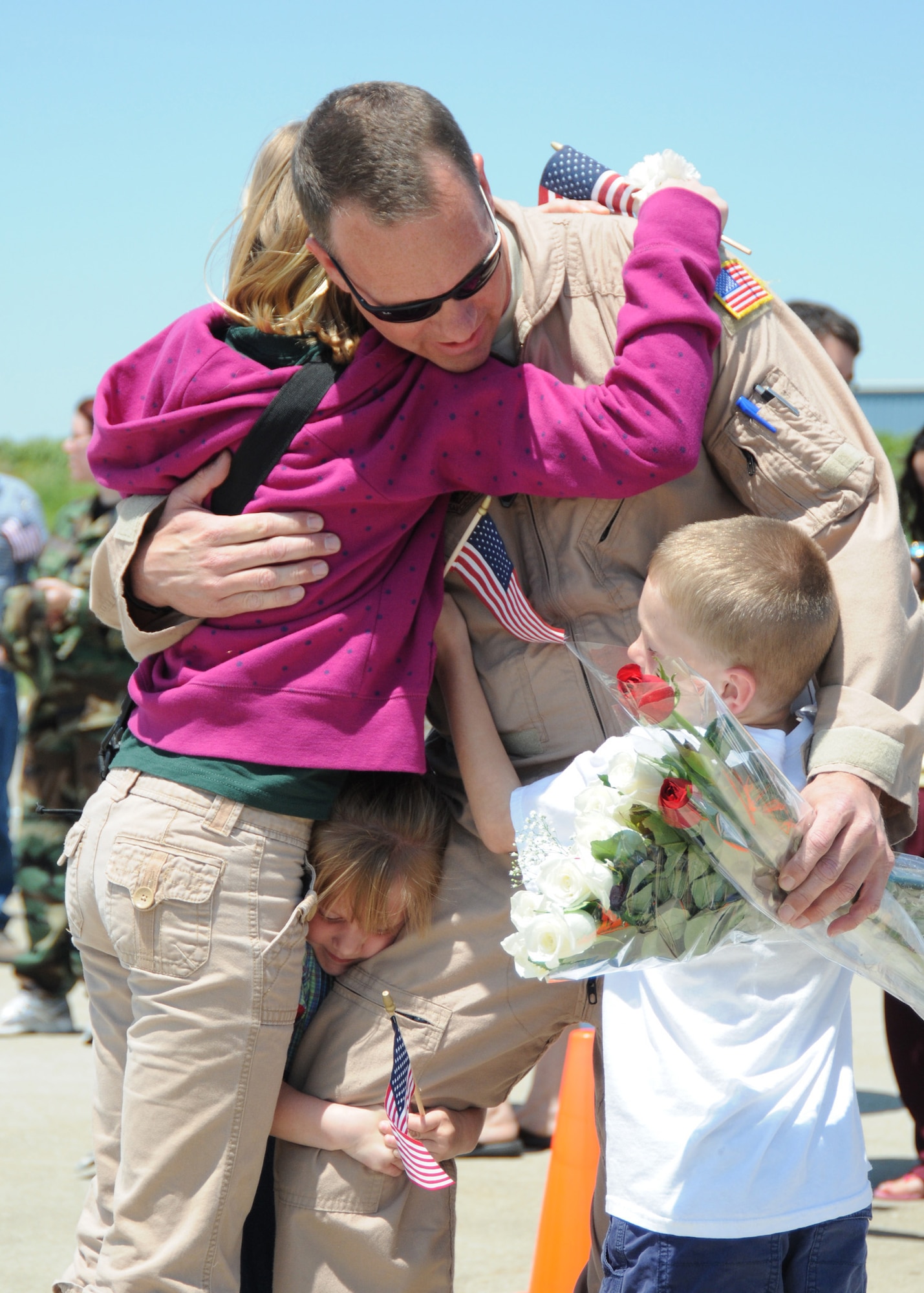 Lt. Col. Scott Wilson hugs his family after returning to Louisville, Ky., from Afganhistan on May 12. (USAF photo by Tech. Sgt. Phil Speck.)