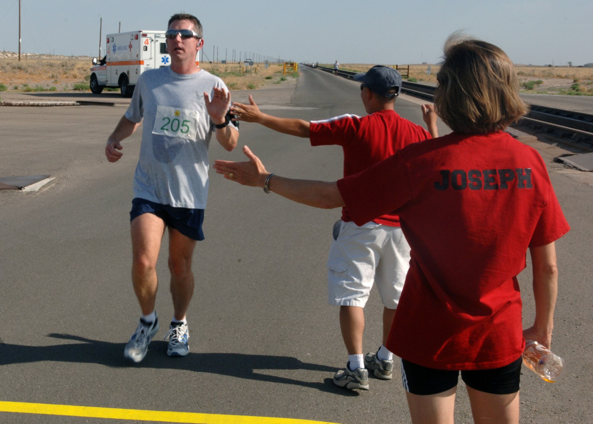 Maj. Tim Loomis, 49th Aerospace Dental Squadron, reaches the finish line after running 10 miles during the Mach 10K Run at Holloman Air Force Base, N.M., May 15. Various static sled displays were available for viewing during and after running 5K, 10K or 10 miles along with prizes awarded to the top runners in each run category. (U.S. Air Force photo/ Airman 1st Class Veronica Stamps)
