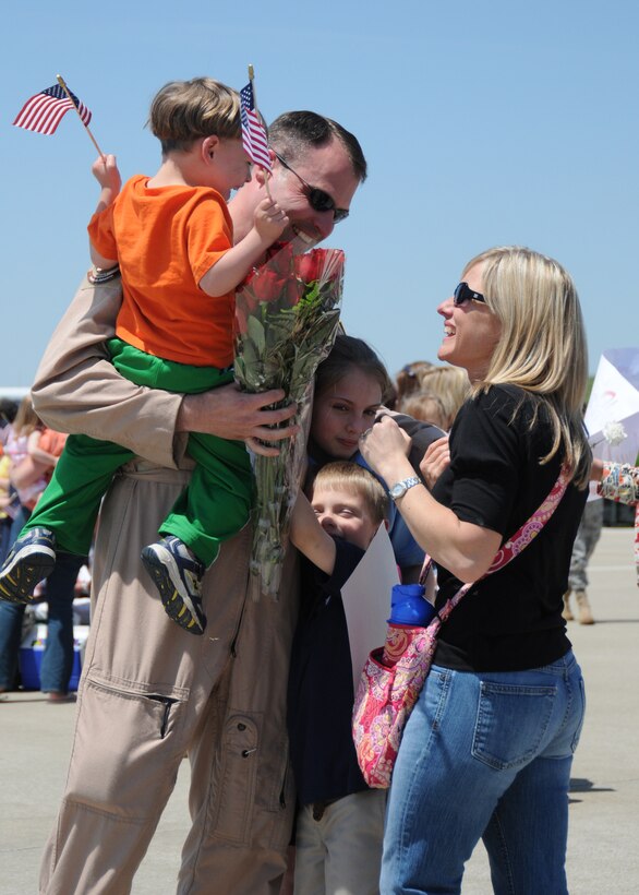 Capt. Bryan Keating is welcomed home by his family on May 12. Captain Keating returned to Louisville, Ky., after a two-month deployment to Afghanistan. (USAF Photo by Tech. Sgt. Phil Speck.)