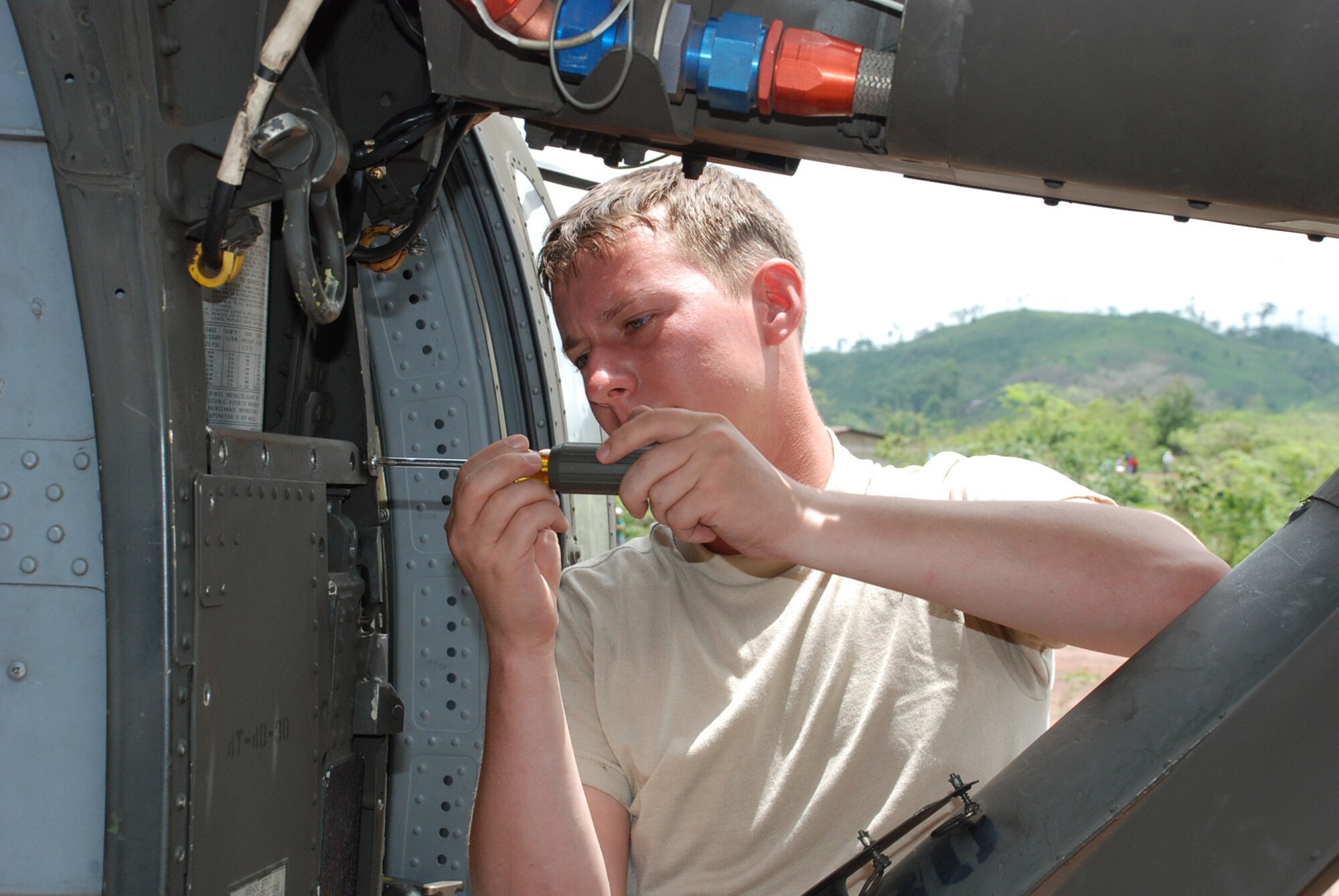 Army Sgt. Danny Hewett, 1st Battalion, 228th Aviation Regiment, inspects the main landing gear of his UH-60 Blackhawk during a 40-hour inspection May 15.  Sergeant Hewett is a Blackhawk crew chief assigned to one of two Joint Task Force-Bravo Blackhawk crews in Nicaragua this week to fly medics and equiment to two remote villages for medical readiness exercises.  (U.S. Air Force photo/Tech. Sgt. Rebecca Danét)